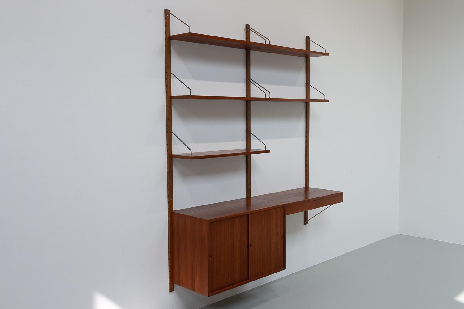 Danish Modern 2-Bay Modular Teak Wall Unit by Poul Cadovius for Cado, 1960s.

Mid-Century Modern 2 bay shelving system model Royal. This is an original vintage floating bookcase designed in 1948 by Danish architect Poul Cadovius. 
Cadovius had the