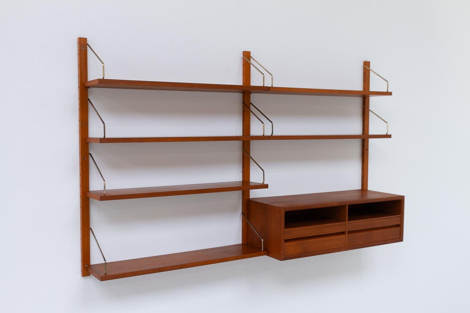 Danish Modern 2-Bay Modular Teak Wall Unit by Poul Cadovius for Cado, 1960s.

Mid-Century Modern 2 bay shelving system model Royal. This is an original vintage floating bookcase designed in 1948 by Danish architect Poul Cadovius. 
Cadovius had the