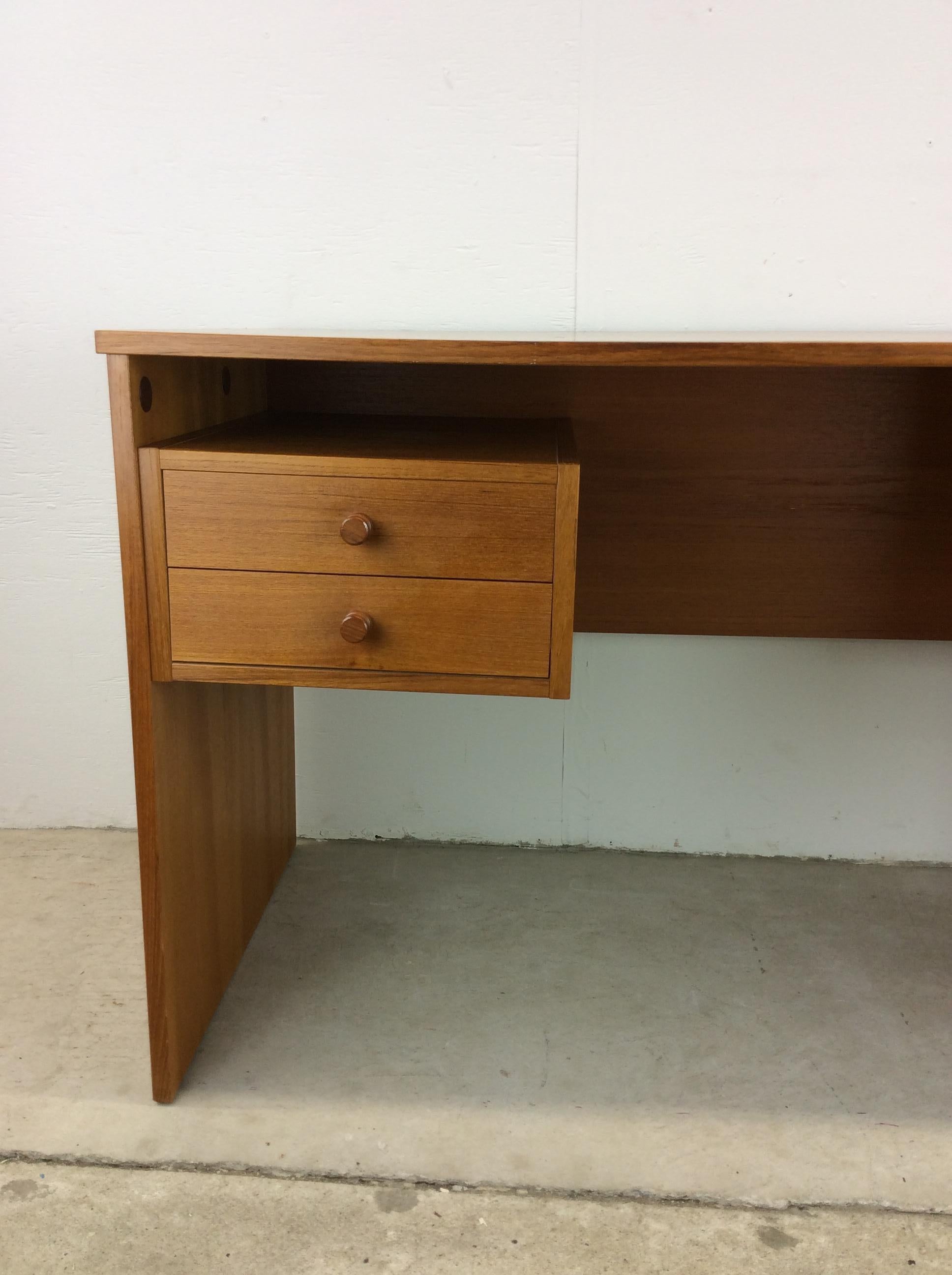 This Danish Modern writing desk features pressed wood construction, teak veneer with original finish, two dovetailed drawers with carved wood pulls, large opened storage shelf, and finished back.

Check out our other Danish Modern listings for