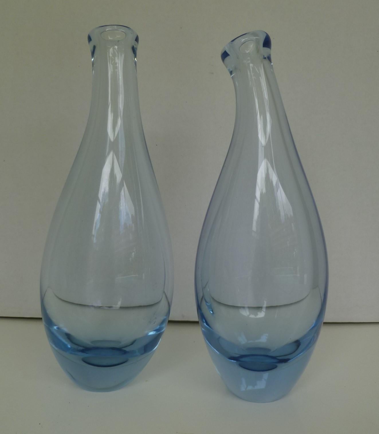 Per Lutken for Holmegaard, Denmark, two tall mouth blown blue glass vases both from 1960. The design of these vases with curved necks was an extension of Per Lutken's highly successful Beak vases of the 1950s. Holmegaard, established in 1823, is