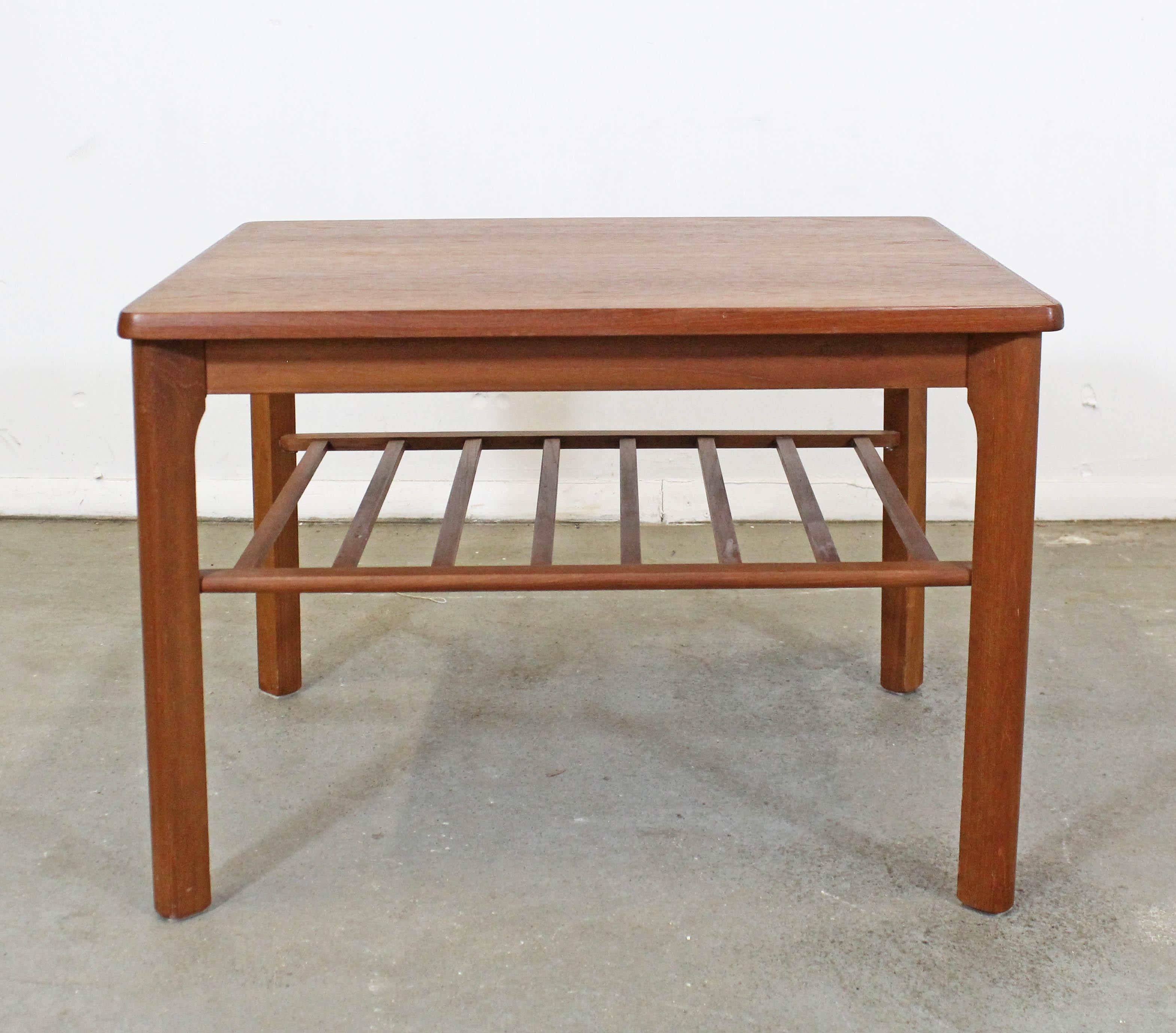 What a find. Offered is a vintage Danish modern end/side table made by Toften Mobelfabrik. It is made of teak and has a bottom rack/shelf. It is in good condition with some age wear including surface scratches and a slight previous repair on the