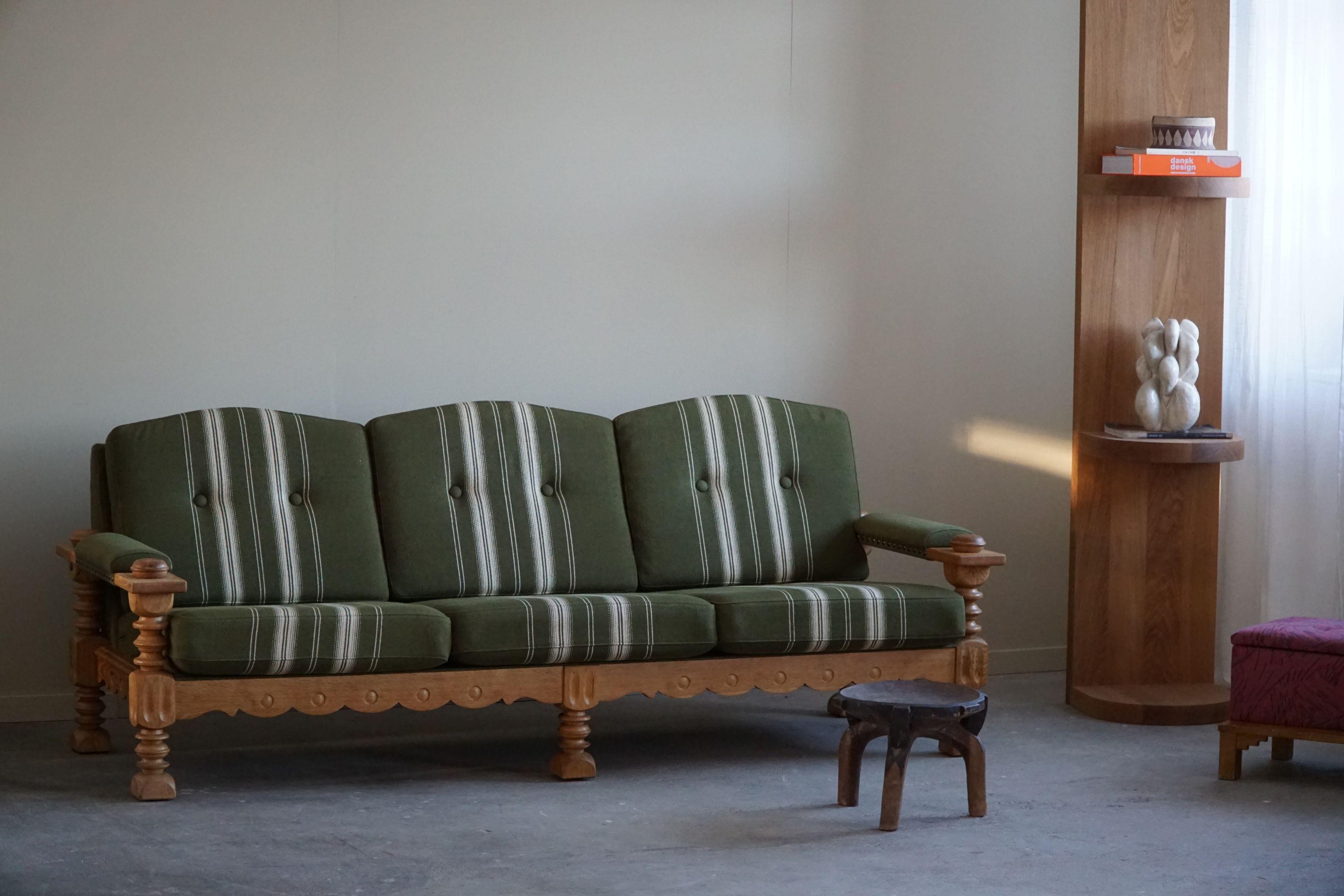 A fascinating sculptural Danish sofa in the manner of Henning (Henry) Kjærnulf. Made in solid oak and its original Savak wool cushions. Made in 1960s by a Danish Cabinetmaker with a great sense for details. The general impression is really