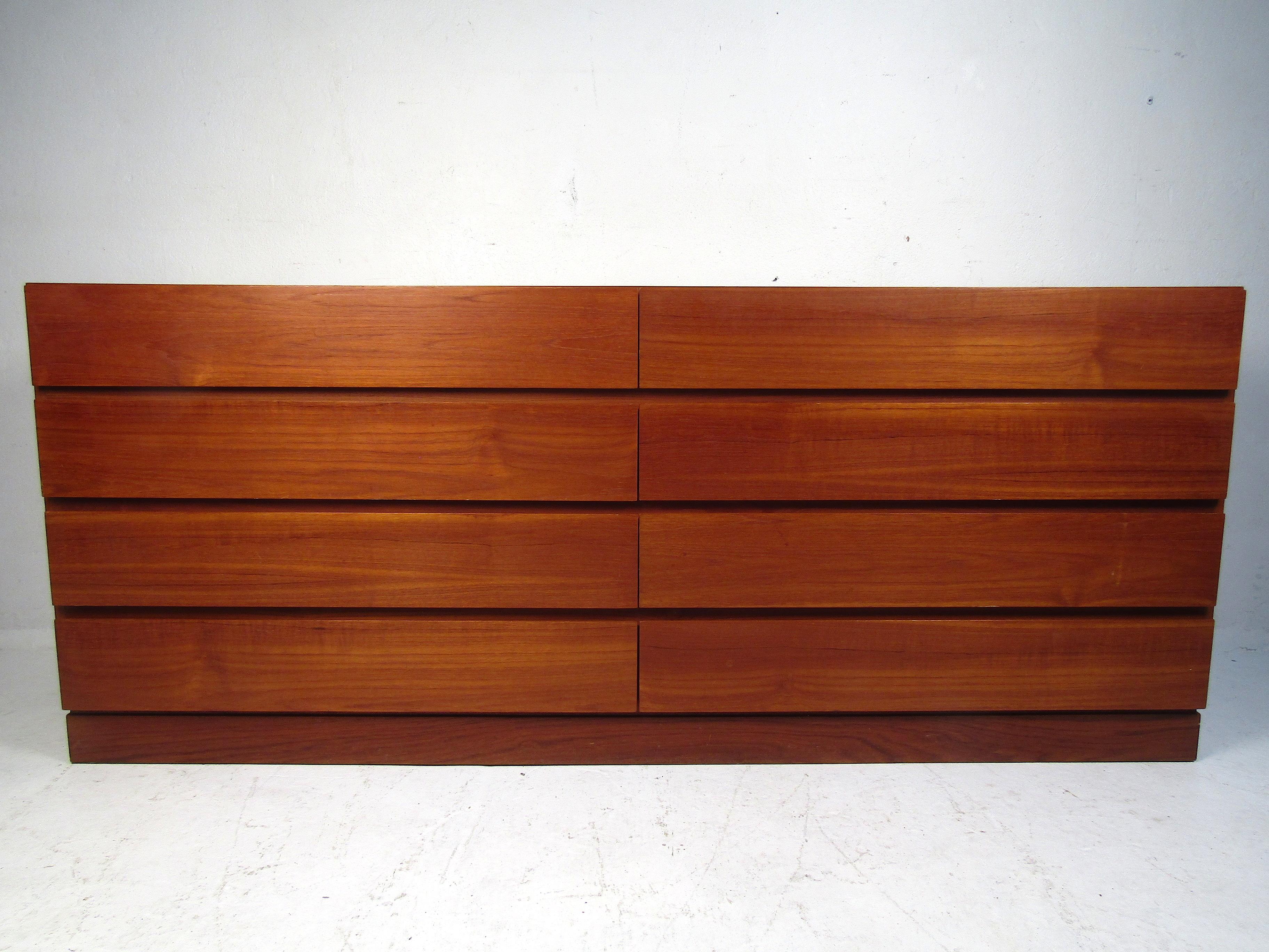 Stylish Danish modern eight-drawer dresser. The piece's exterior is covered in a good-looking teak veneer. Sure to make a nice addition to any modern interior. Please confirm item location with dealer (NJ or NY).