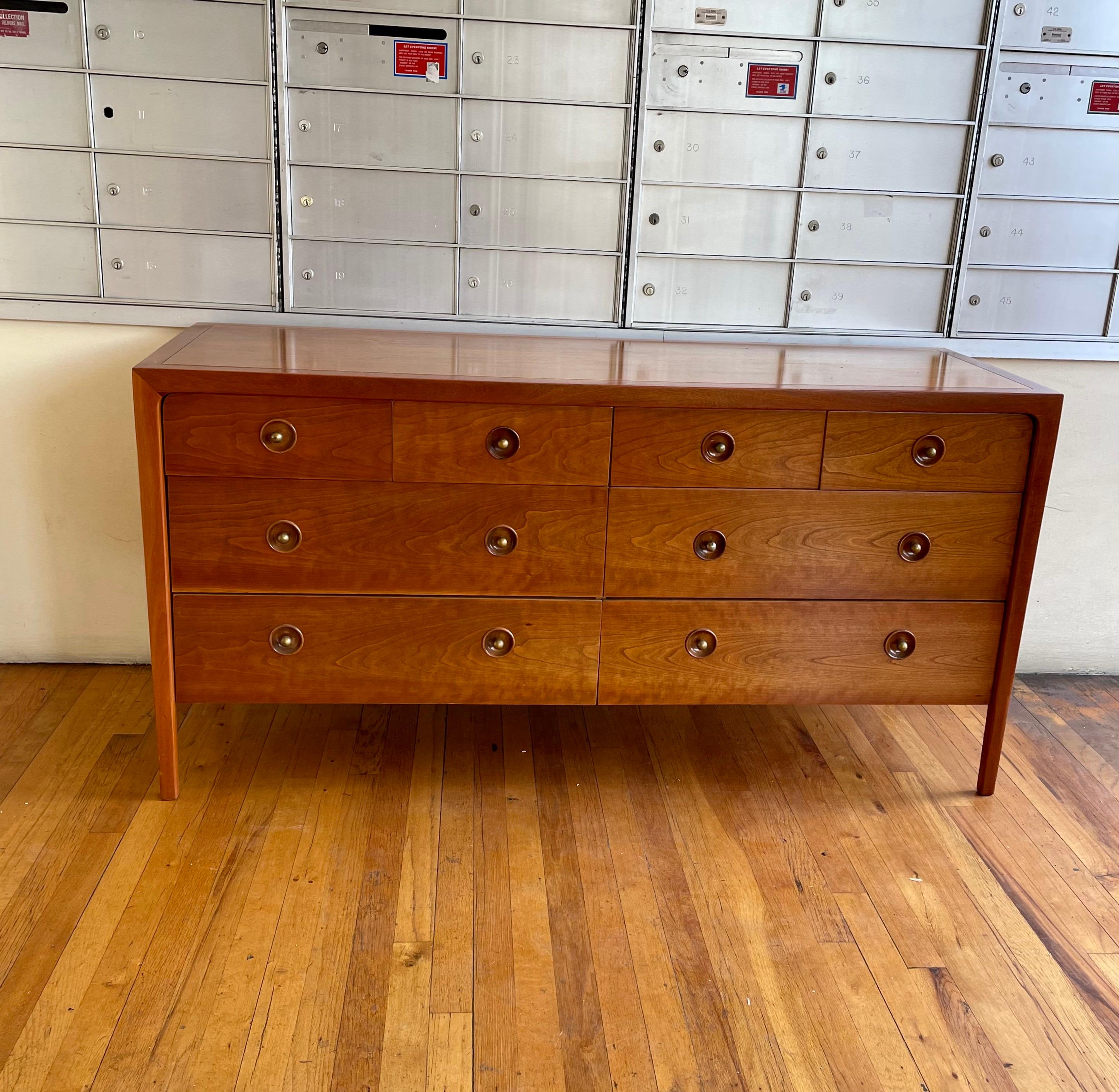 Beautiful simple elegant 8-drawer dresser by Drexel designed by John Van Koert part of the Counterpoint line circa the 1960s freshly refinished with brass handles. In light walnut finish. with a mahogany edge.