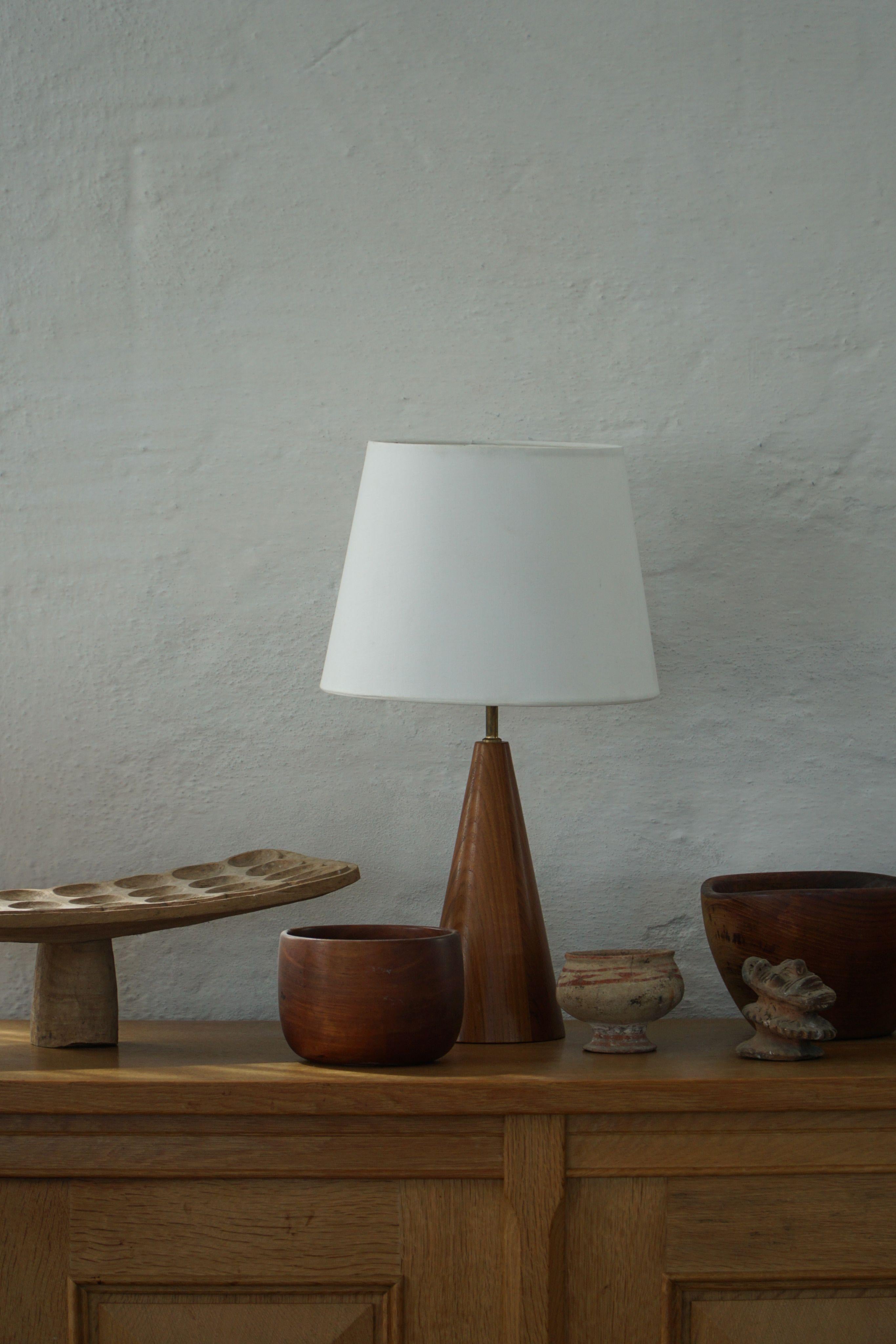 A fine sculptural vintage table lamp in solid teak. Made by a Danish cabinetmaker in the 1980s. It will complement many interior styles. A Modern, Classic, Scandinavian or an Art Deco home decor.

A warm color and patina that pairs well with the
