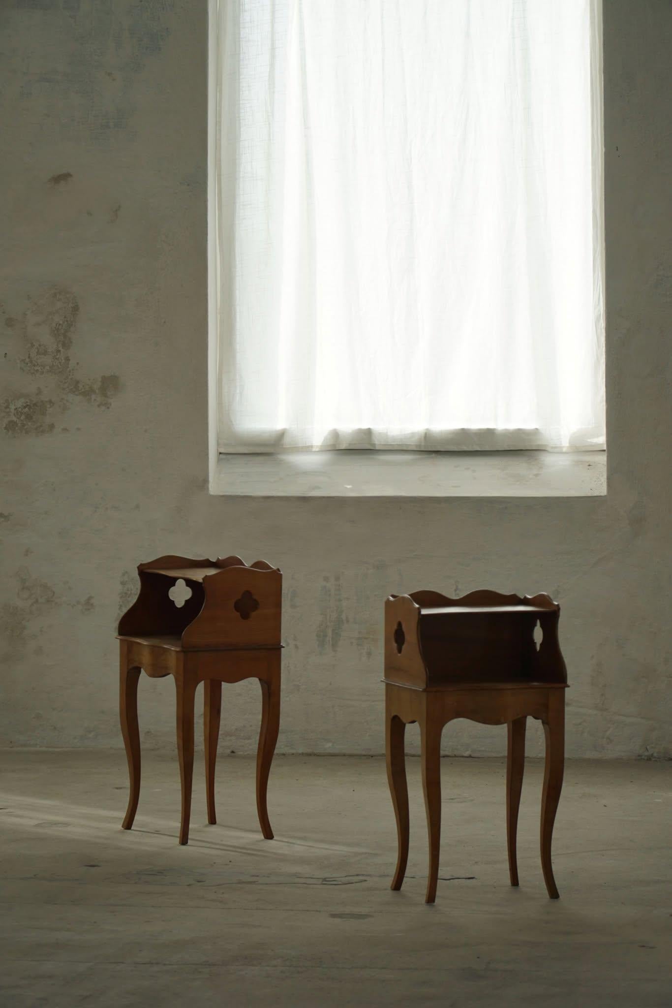 A sophisticated pair of tall nightstands / bedside tables crafted in rich nutwood, showcasing the timeless elegance of Danish Modern design. Made by a skilled Danish cabinetmaker in the 1940s, these pieces exemplify the refined craftsmanship and