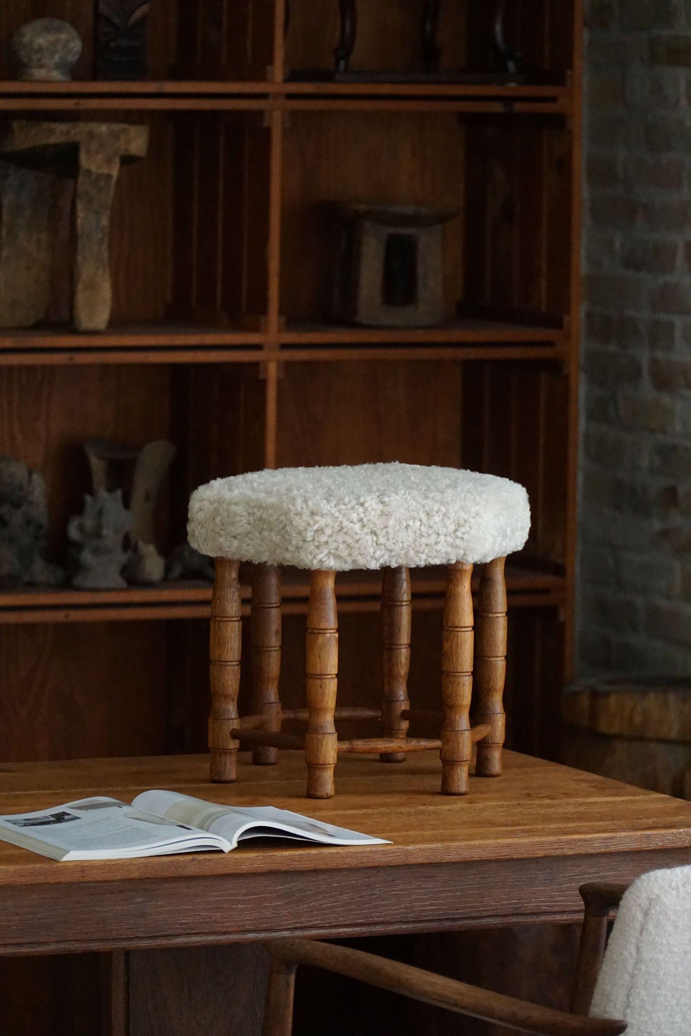 Un hermoso taburete danés moderno de roble con patas rizadas, el asiento hexagonal retapizado en una lana de cordero shearling de gran calidad. Fabricado por un ebanista danés en la década de 1950. Un taburete fino con una impresión intrigante.

Un