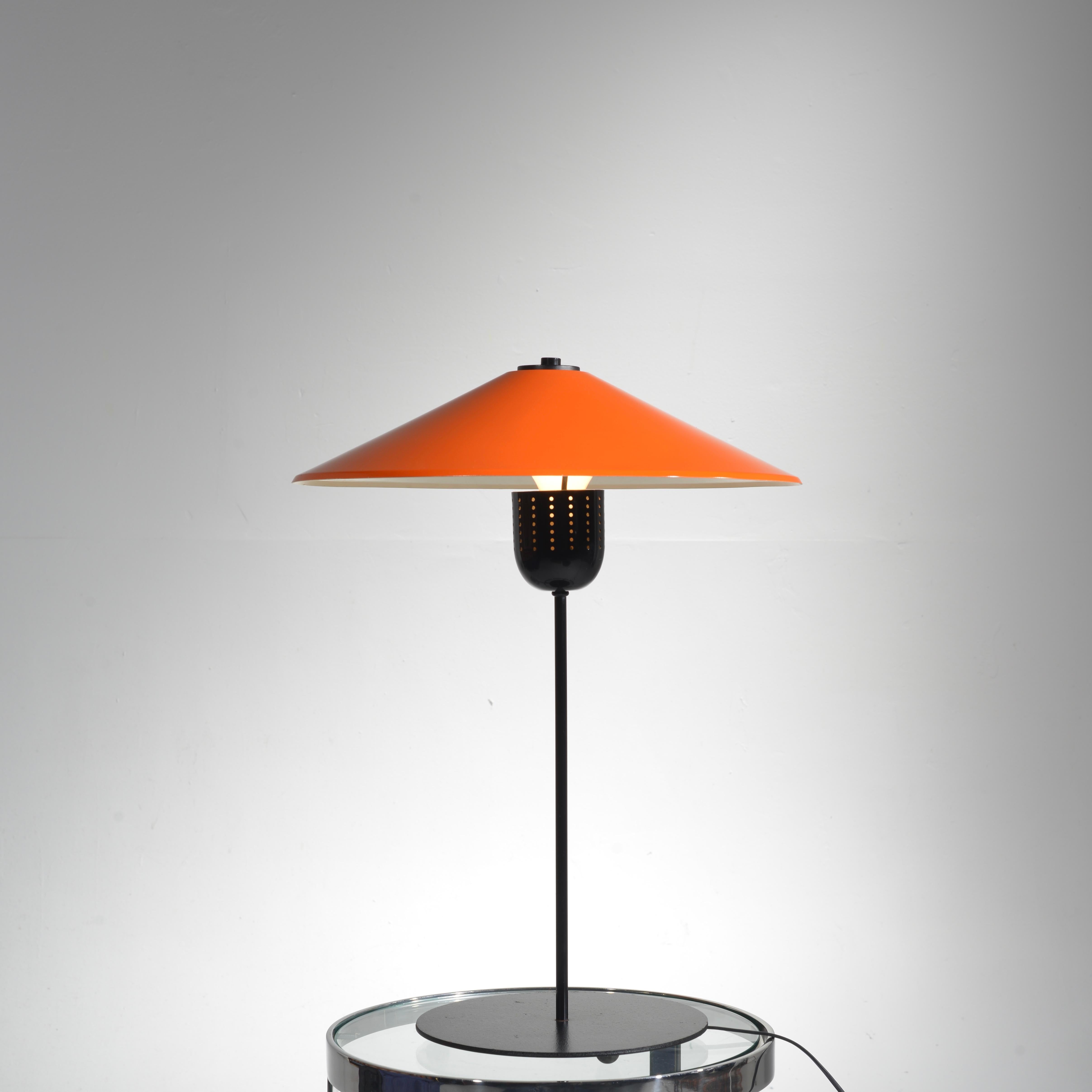 This beautiful orange Danish modern table lamp is in excellent condition. The shade can tilt at different angles.