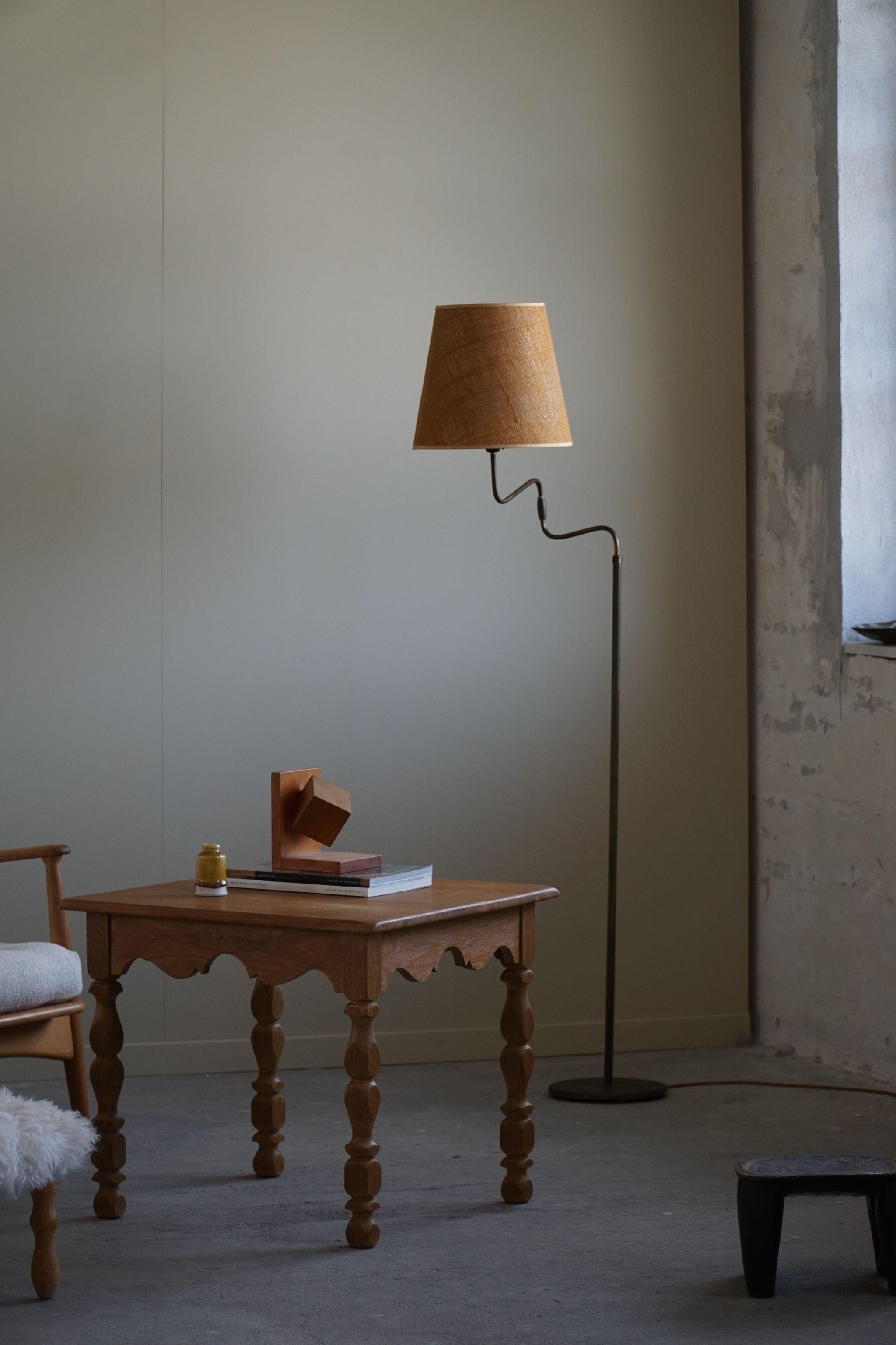 This Danish Modern adjustable floor lamp from the 1950s is a beautiful and functional piece of midcentury design. The lamp is made in brass, which has been expertly crafted to create a sleek and elegant Silhouette.

The lamp is adjustable,