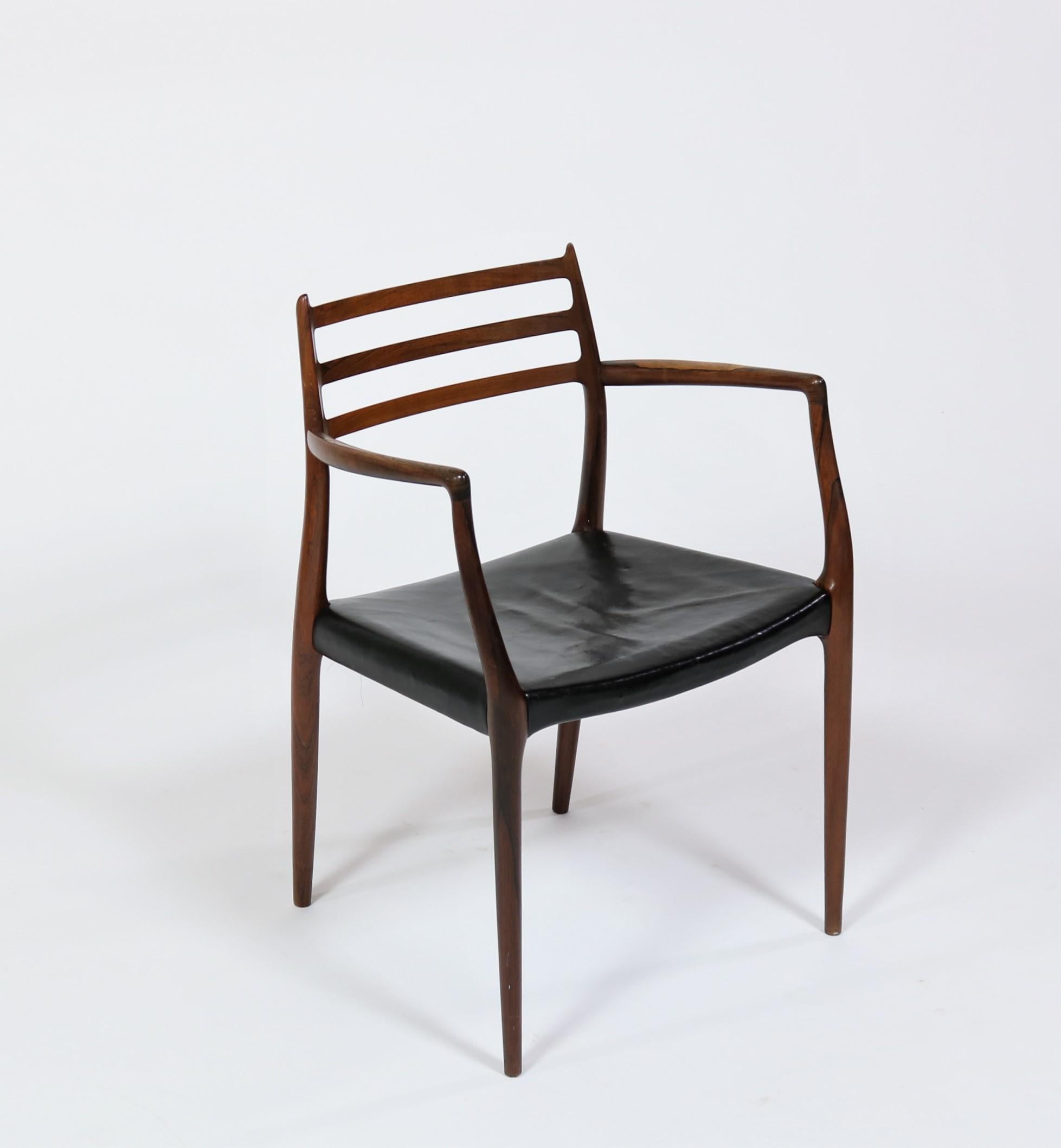 Stunning craftmanship meets brilliant design in this Brazillian rosewood armchair designed by Niels Moller for J.L. Moller Mobelfabrik, Denmark, 1962. All original condition with beautiful wear and patina to wood and leather. Iconic and amazing