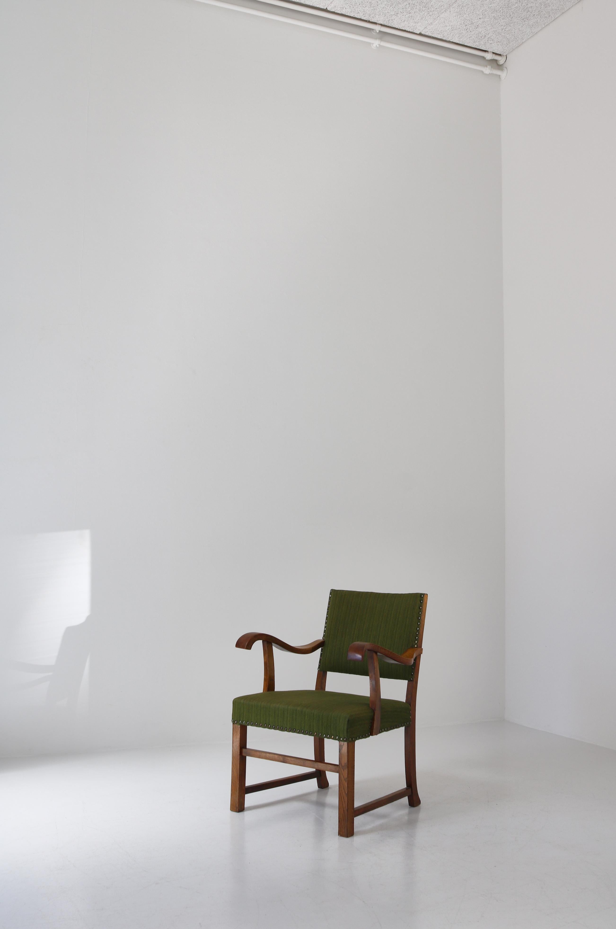 Early Danish Modern armchair with curved armrests made in the 1940s by cabinetmaker S. Thrane, Odense, Denmark. The design is clearly influenced by the functionalist movement introduced in Danish furniture design by Kaare Klint. The chair retains