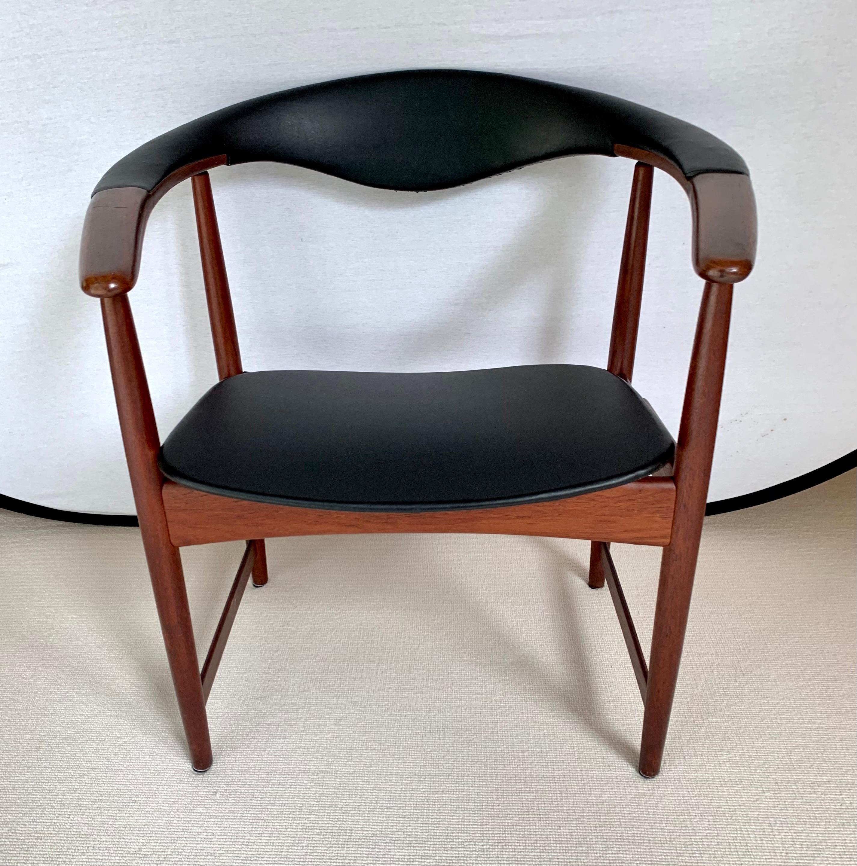 Vintage Danish modern armchair designed by Arne Hovmand-Olsen with a rounded back and black leather upholstery. Signed on the underside.