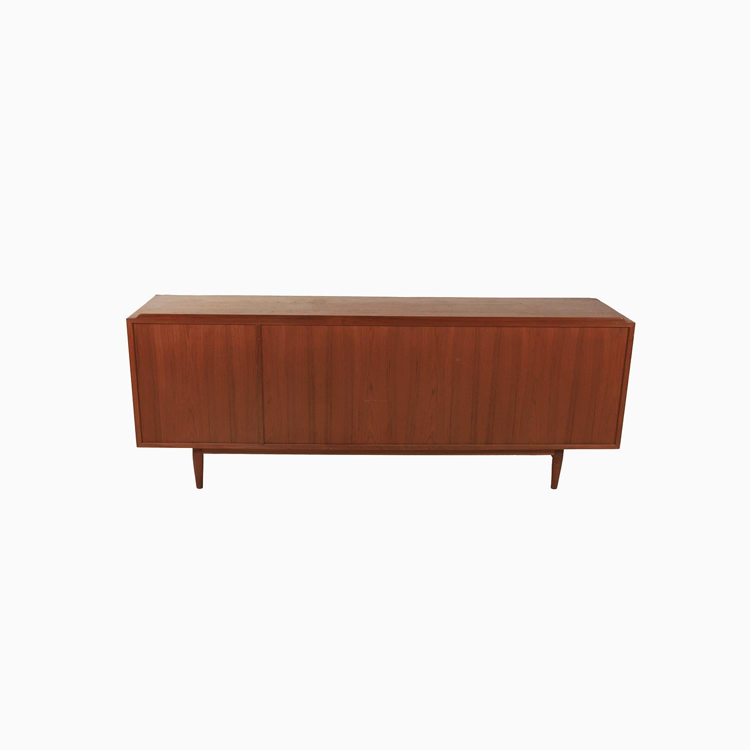 An iconic sideboard designed by Arne Vodder for Sibast. Teak cabinet with reversible doors. Lots of storage behind the sliding doors with a right bank of vertical drawers. An eye catching piece of Danish design.

Professional, skilled furniture