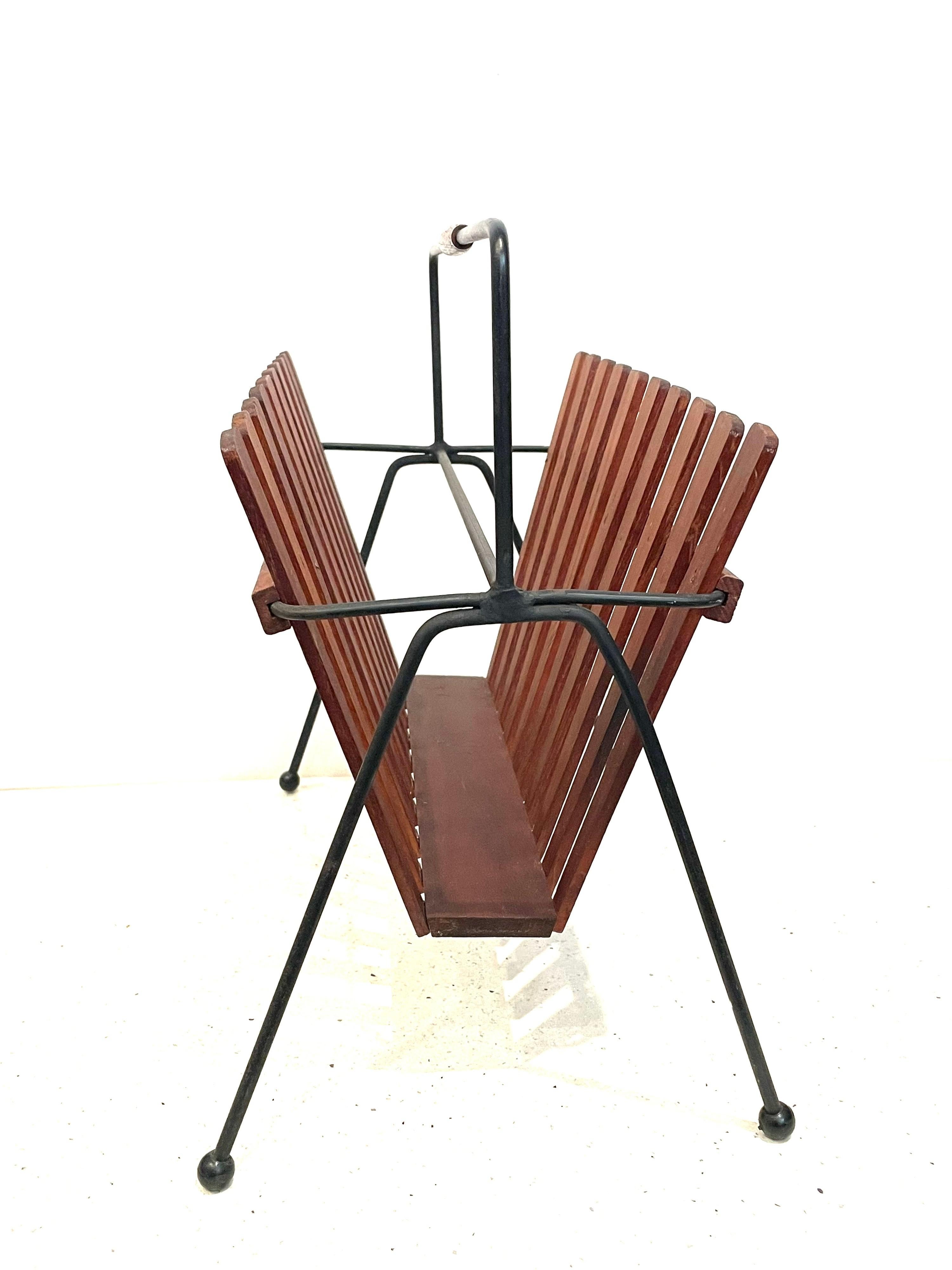 Versatile and hard-to-find iron and teak magazine rack, circa 1950's great condition and design.