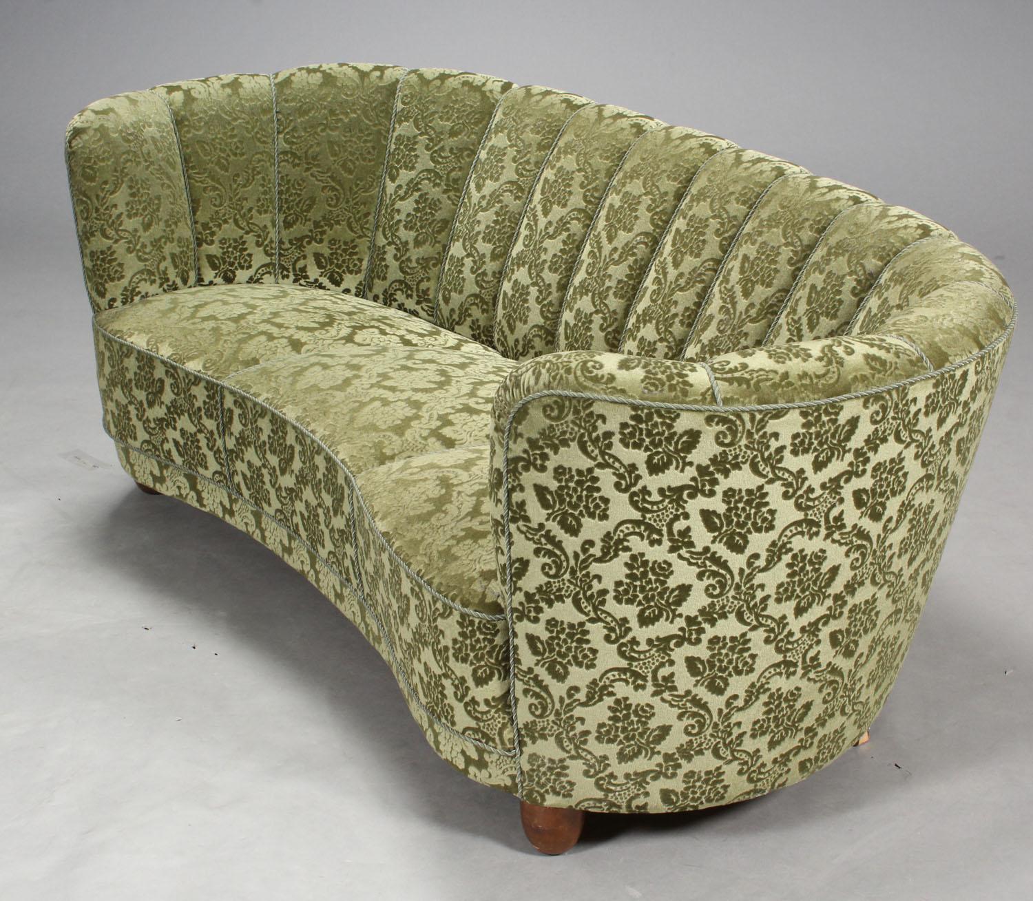 Danish modern cabinet maker, freestanding 'banana' sofa upholstered in green patterned velour, curved back and front, round forelegs of stained beechwood.