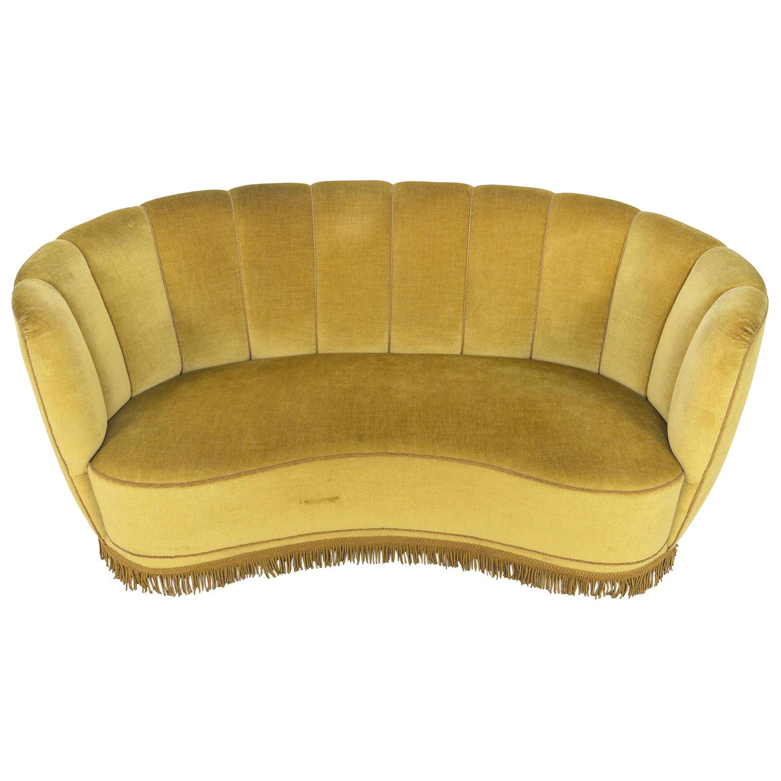 This beautifully preserved Danish modern velvet banana sofa was crafted in the 1950s. Covered in chartreuse velvet, this scalloped design is adorned with coordinated welting and fringe. In excellent original condition.

  