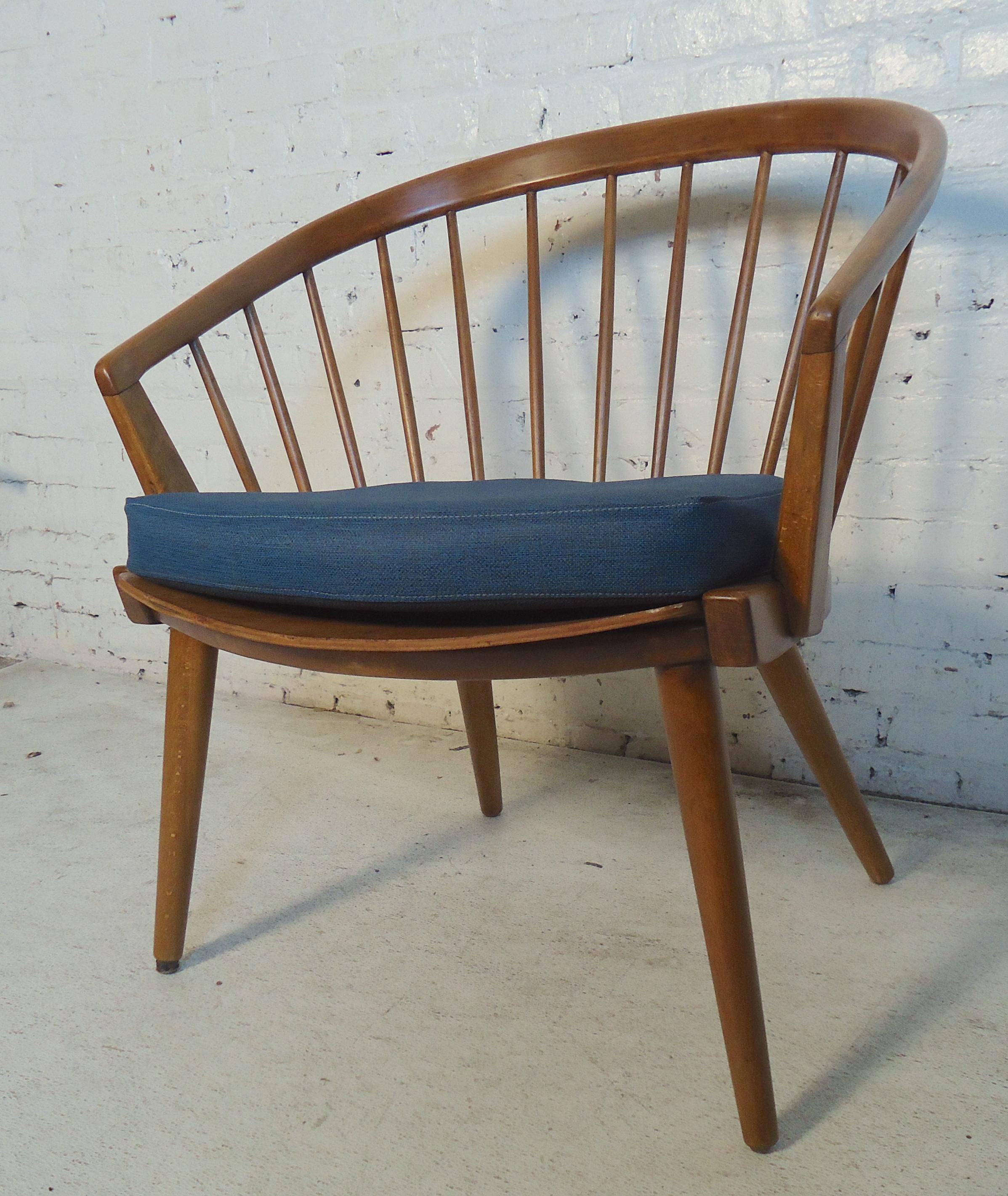 This beautiful Mid-Century Modern chair is made of rich teak grain in this Hans Wegner style frame. Stands on tapered legs, has a wide seat and rounded back rest with round spindles.

Please confirm item location (NY or NJ.)