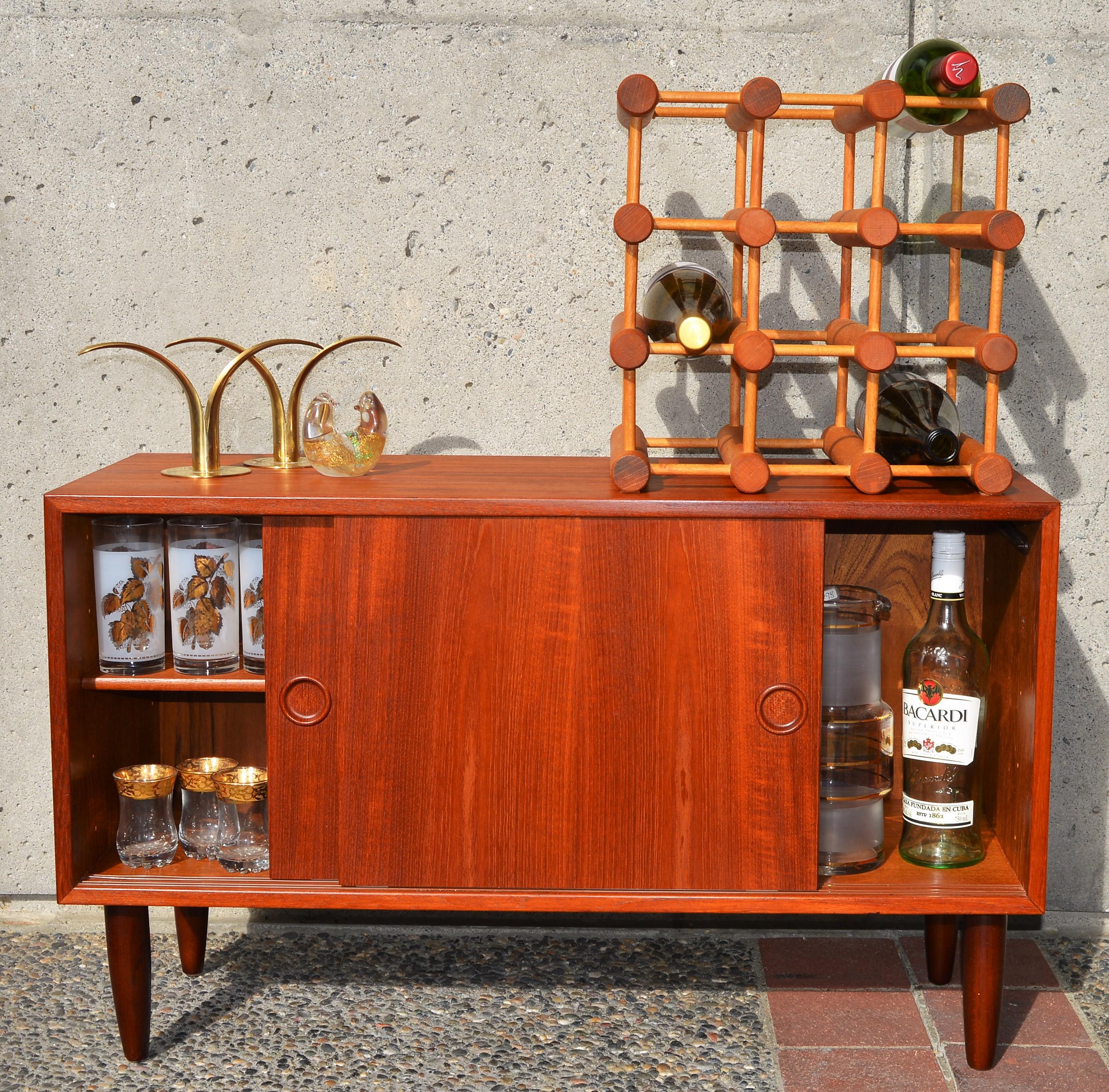 This classic iconic Danish modern modular wine rack by Nissen Langaa holds 12 bottles and can be changed configuration to any that suits. Made of solid wood stamped with the Nissen logo on the ends of many of the larger pieces. In wonderful