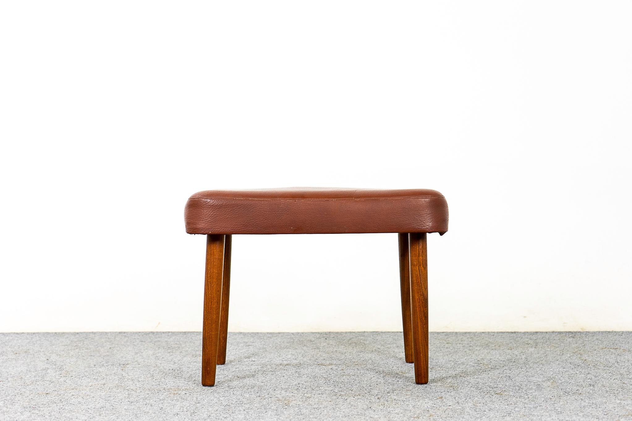 Beech & vinyl footstool, circa 1960's. Original brown vinyl and solid beech wood legs.  Compact design can be used with virtually any seating type.

Please inquire for remote and international shipping rates.