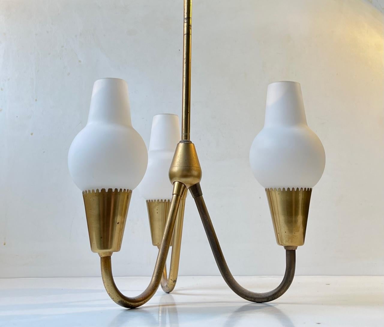 A small beautifully crafted 3-shaded hanging lamp with subtle mid-century detailing. It was designed by Bent Karlby and manufactured by Lyfa in Denmark during the 1950s, stylistically it is very much in line with similar fixtures by Paavo Tynell and
