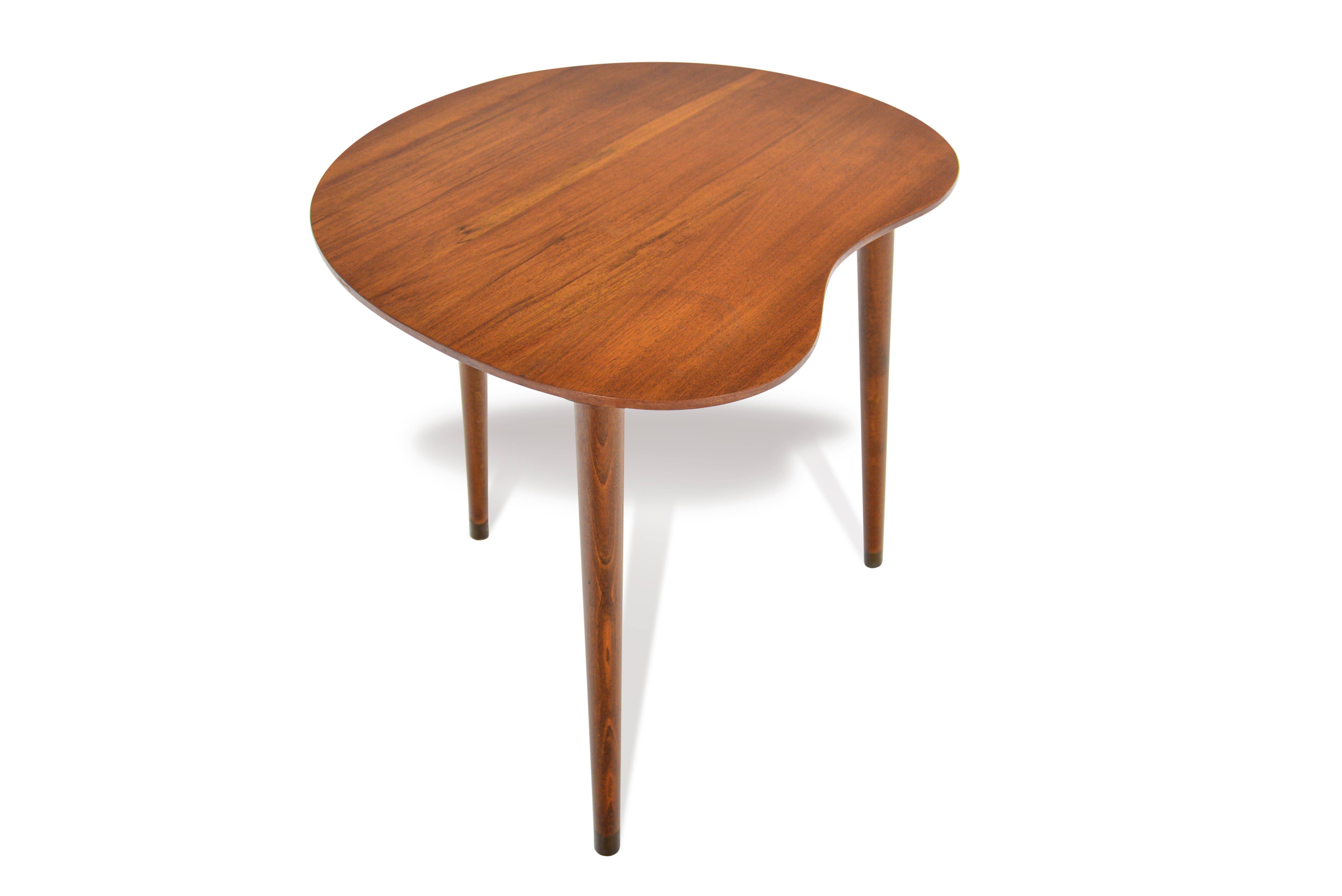 This Danish modern biomorphic shaped side table in elm is finished on all sides and offers organic lines. This rare find is a perfect companion piece for any lounge chair, sofa, or bedside. In excellent vintage condition.

  