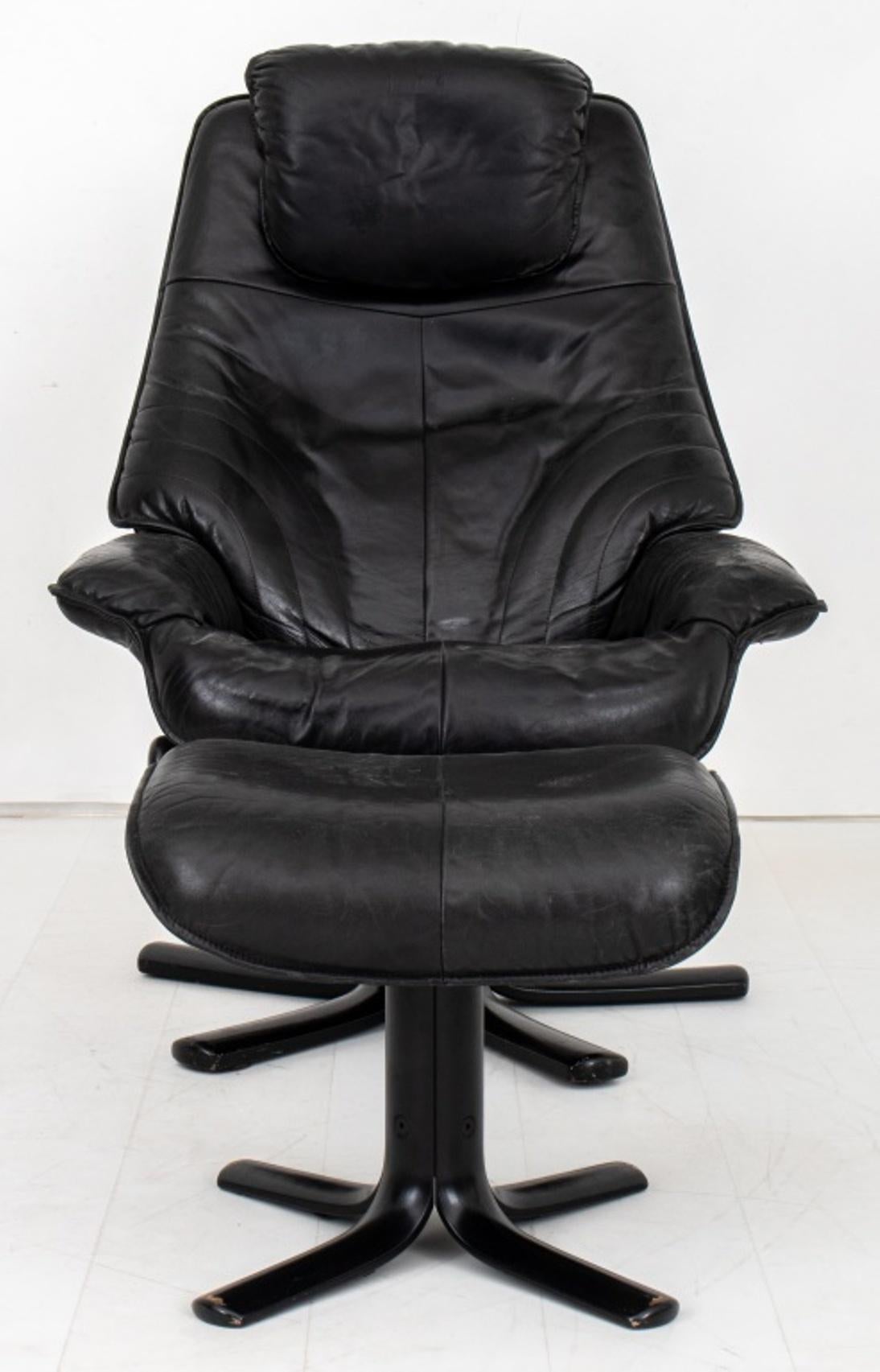 Danish modern black leather chair and ottoman, with upholstered seat and arms, above a five footed star base.
Dimensions: 42
