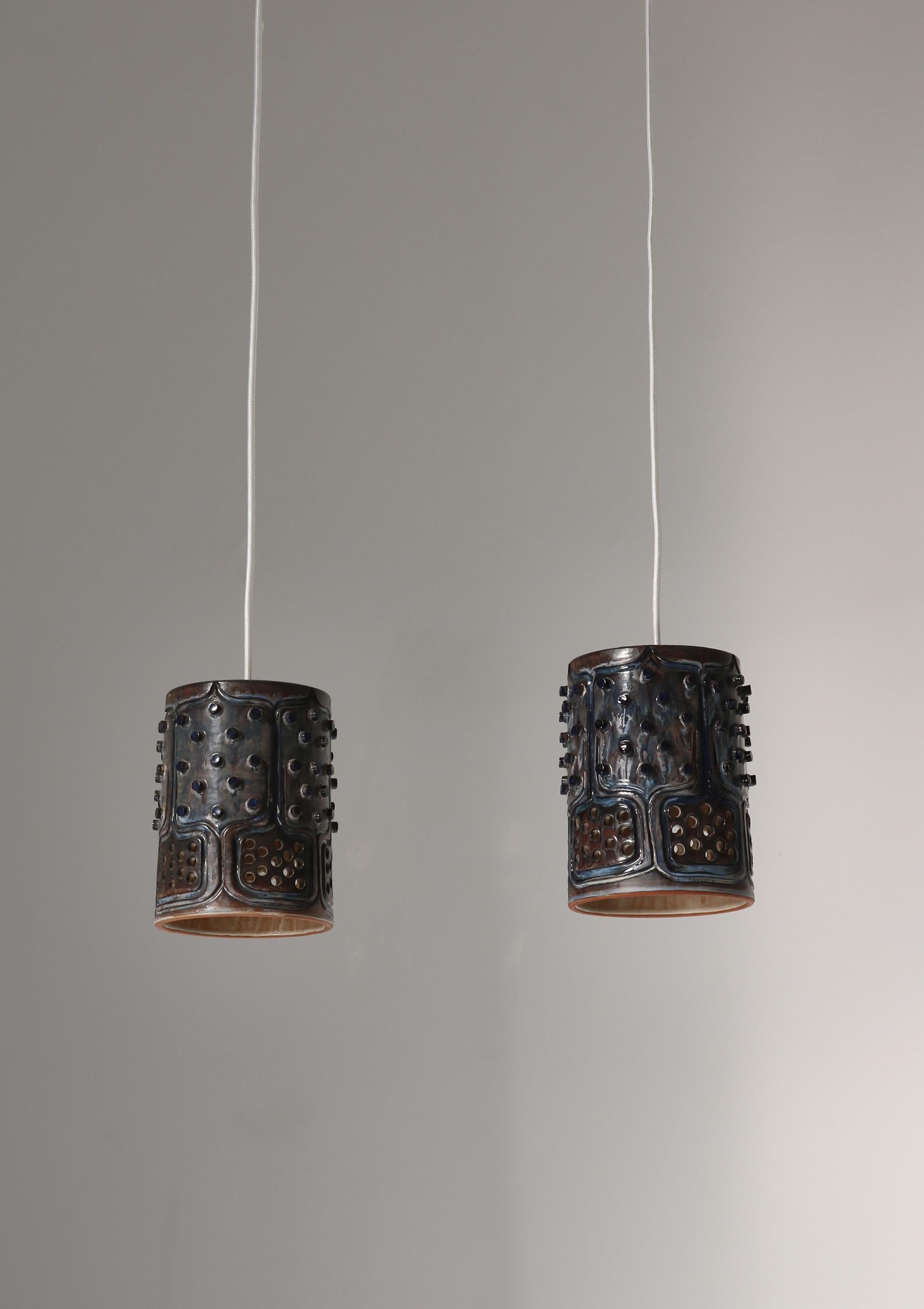 Unique pendants handmade in the 1970s by artist Jette Hellerøe at Axella studio, Denmark. The lamps are made from stoneware and finished in an expressive glossy glazing in blue colors. Stamped with 