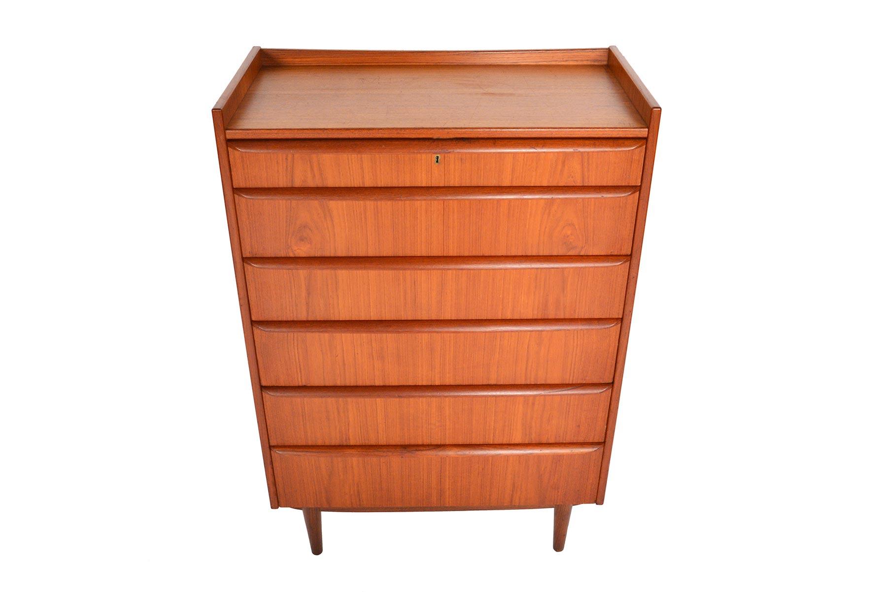 This gorgeous Danish modern six-drawer midcentury teak highboy dresser offers a stunning profile. Drawers become progressively deeper towards the base. Banded in beautifully contrasting afrormosia, each drawer features a full profile pull. A