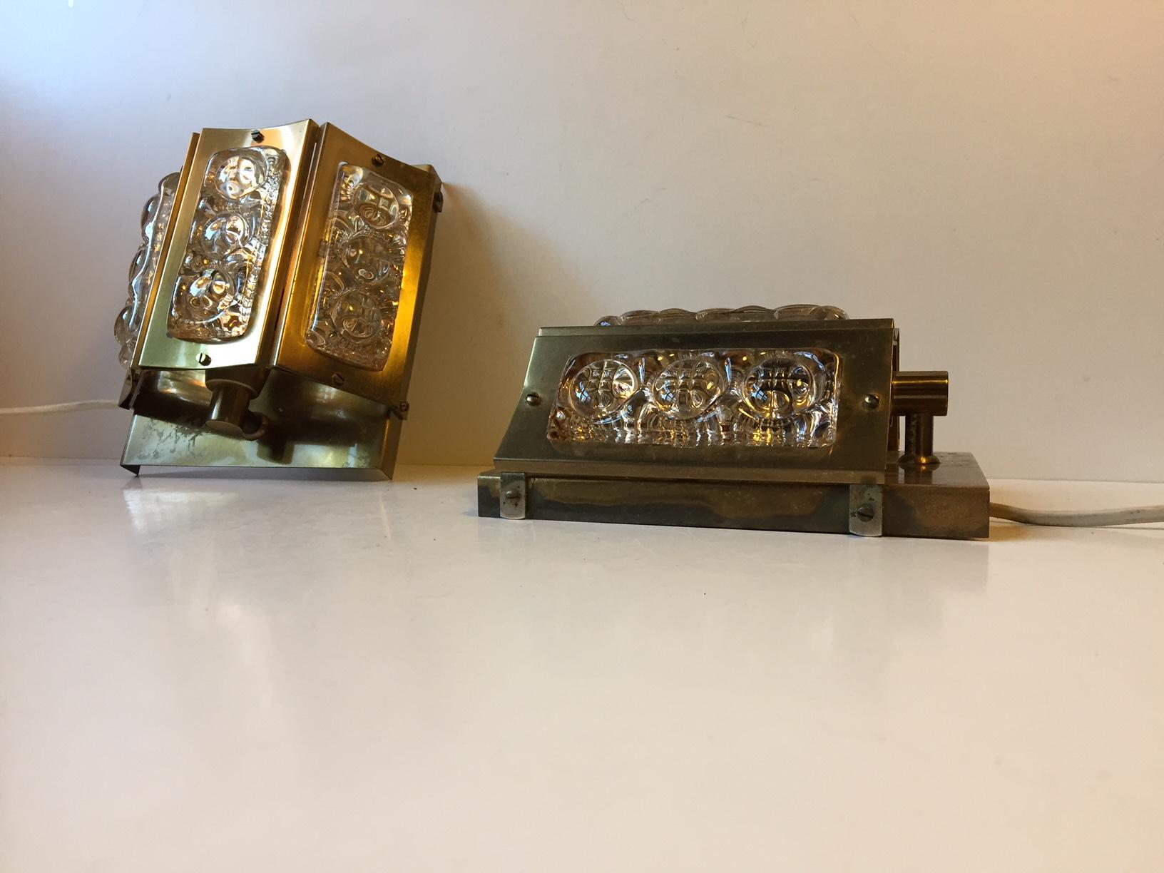 These sconces were manufactured and designed by Vitrika in Denmark in the 1960s. Tis model is made from solid brass set with thick textured glass panels.