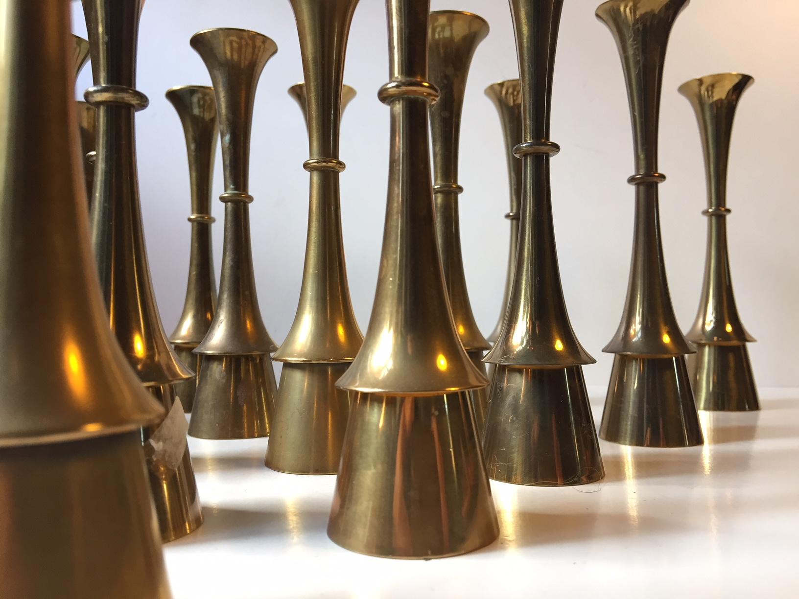 Group of 15 solid brass candlesticks designed and manufactured by Hyslop in Copenhagen, Denmark during the 1960s. The candlesticks are to be fitted with regular sixed candles. They have not been polished recently and all of them display a patina. If