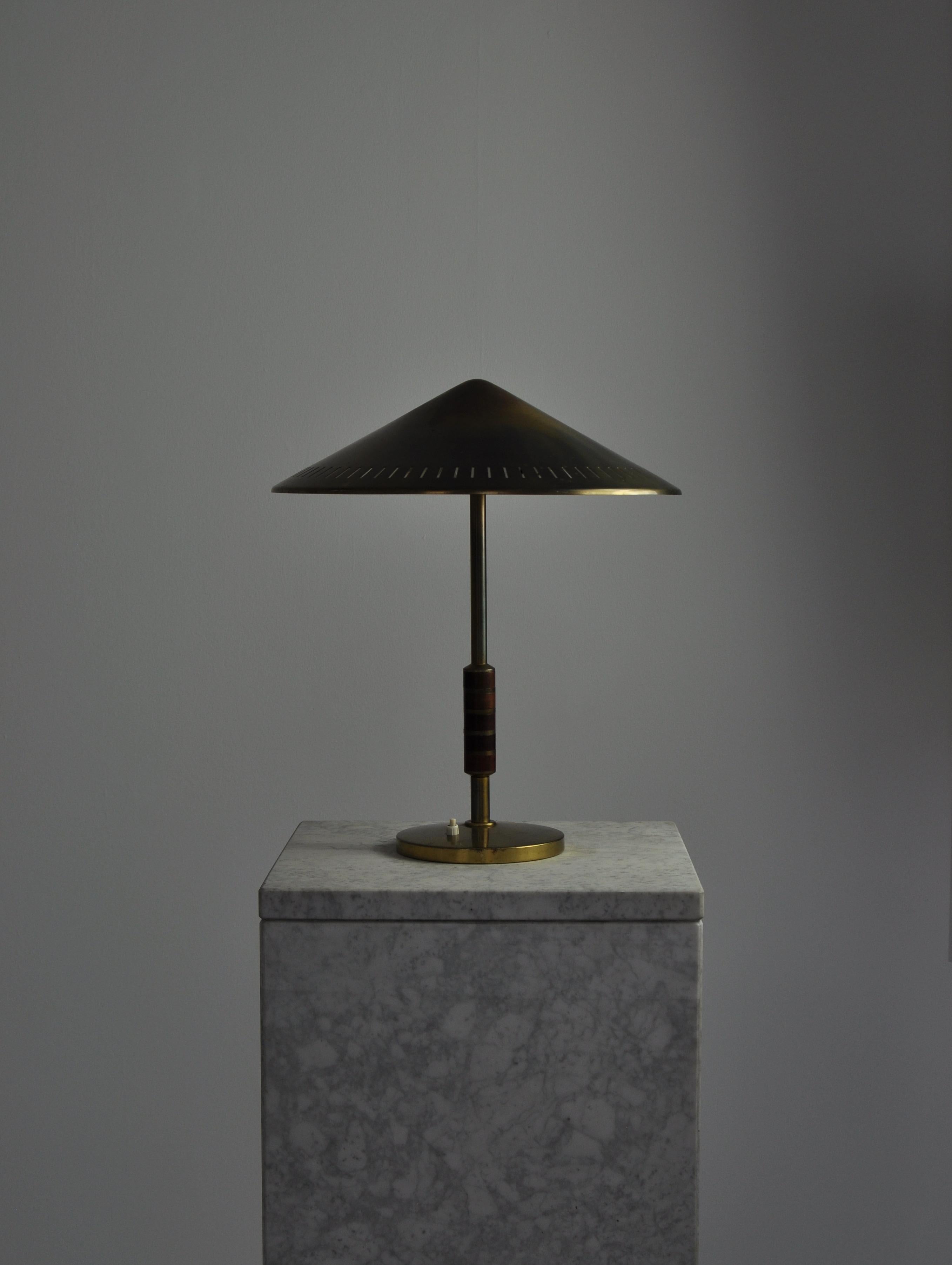 Large table lamp in solid brass with mahogany handle. Manufactured by LYFA, Copenhagen in the 1950s and designed by Danish designer Bent Karlby. The lamp has two light sources. Great original condition.