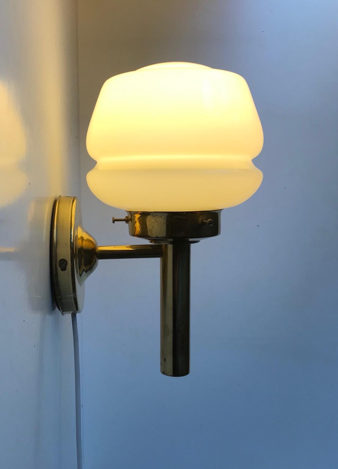 Art Deco revival sconce with vague yellow opaline glass shade manufactured and designed by Abo Metalkunst in a style reminiscent of Hans Agne Jakobsson and Michael Anastassiades some 40 years later. Nice vintage and working order with a light patina