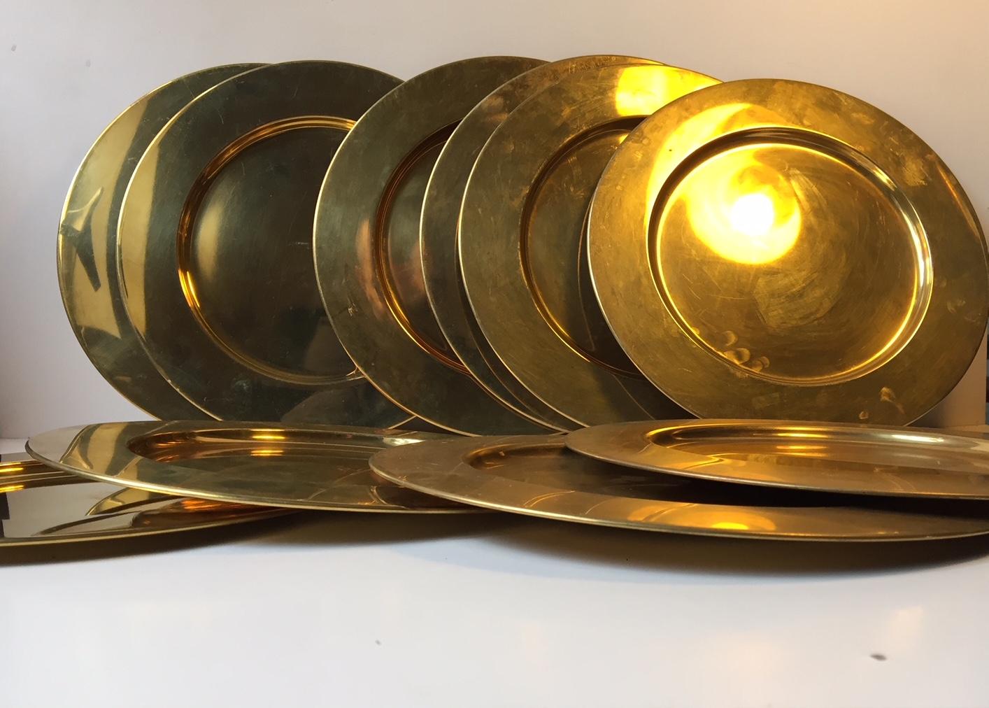 A set of 10 brass plates or cover plates. They were manufactured and designed in Denmark by Boye's during the 1970s. These plates are very similar to plates made by Stelton 5-10 years earlier. Some plates are thought to be unused.