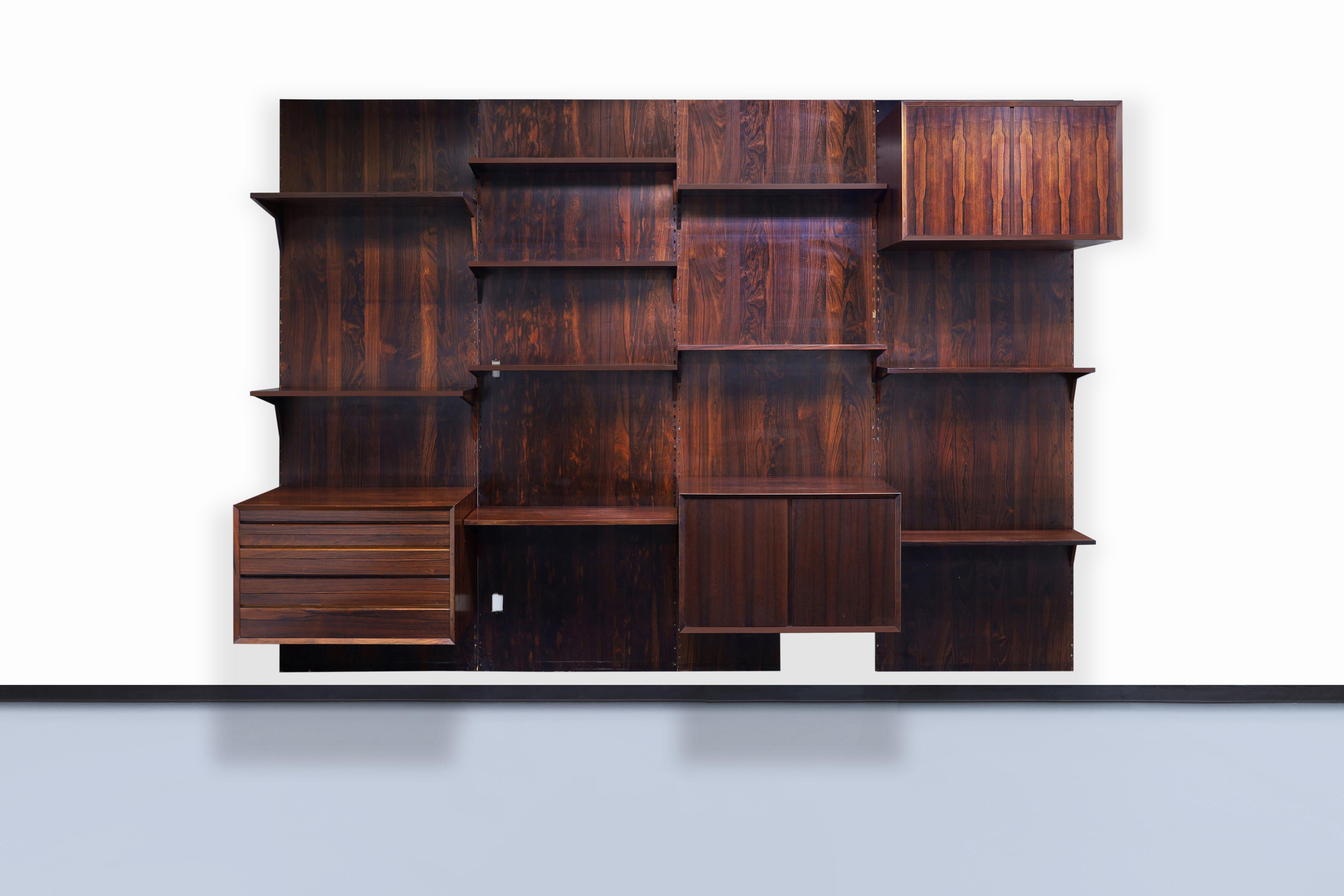 Exceptional Danish modern Brazilian rosewood wall unit by Poul Cadovius for Cado in Denmark, circa 1960s. This wall unit has been constructed from the highest quality Brazilian rosewood, and thanks to the wood's grains, it gives the structure