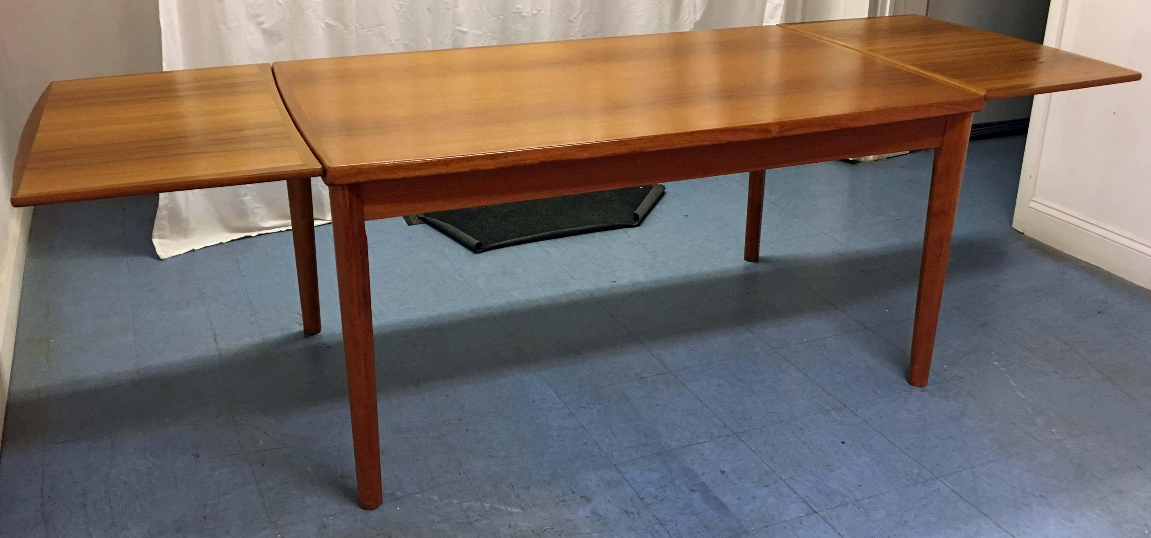 Offered is an extendable teak dining table by BRDR Furbo. It includes two extension boards and is made of teak. Has been refinished.

Approximate dimensions:
With extension boards: 104