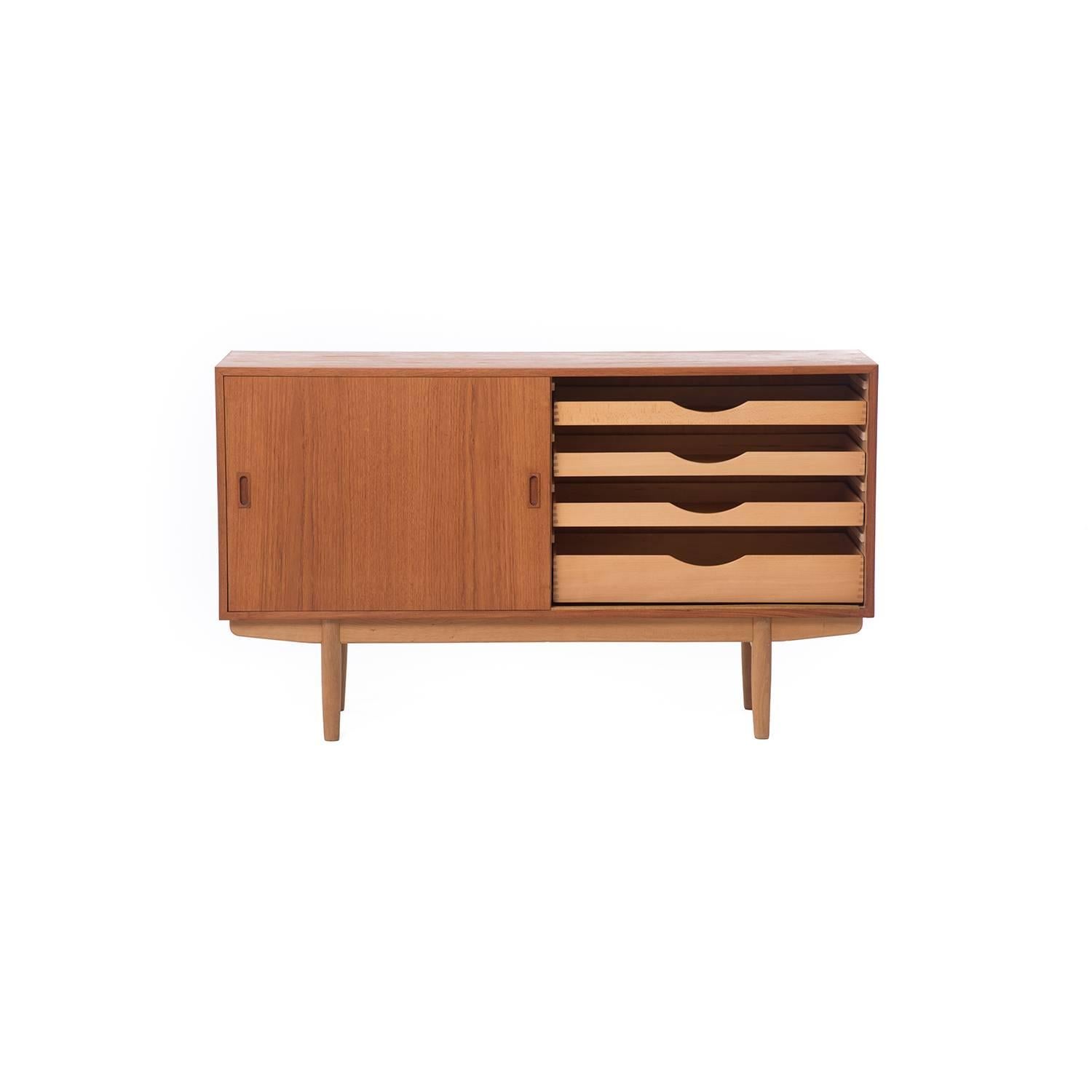This Børge Mogensen teak sideboard with oak legs features a series of adjustable shelves as well as four drawers.