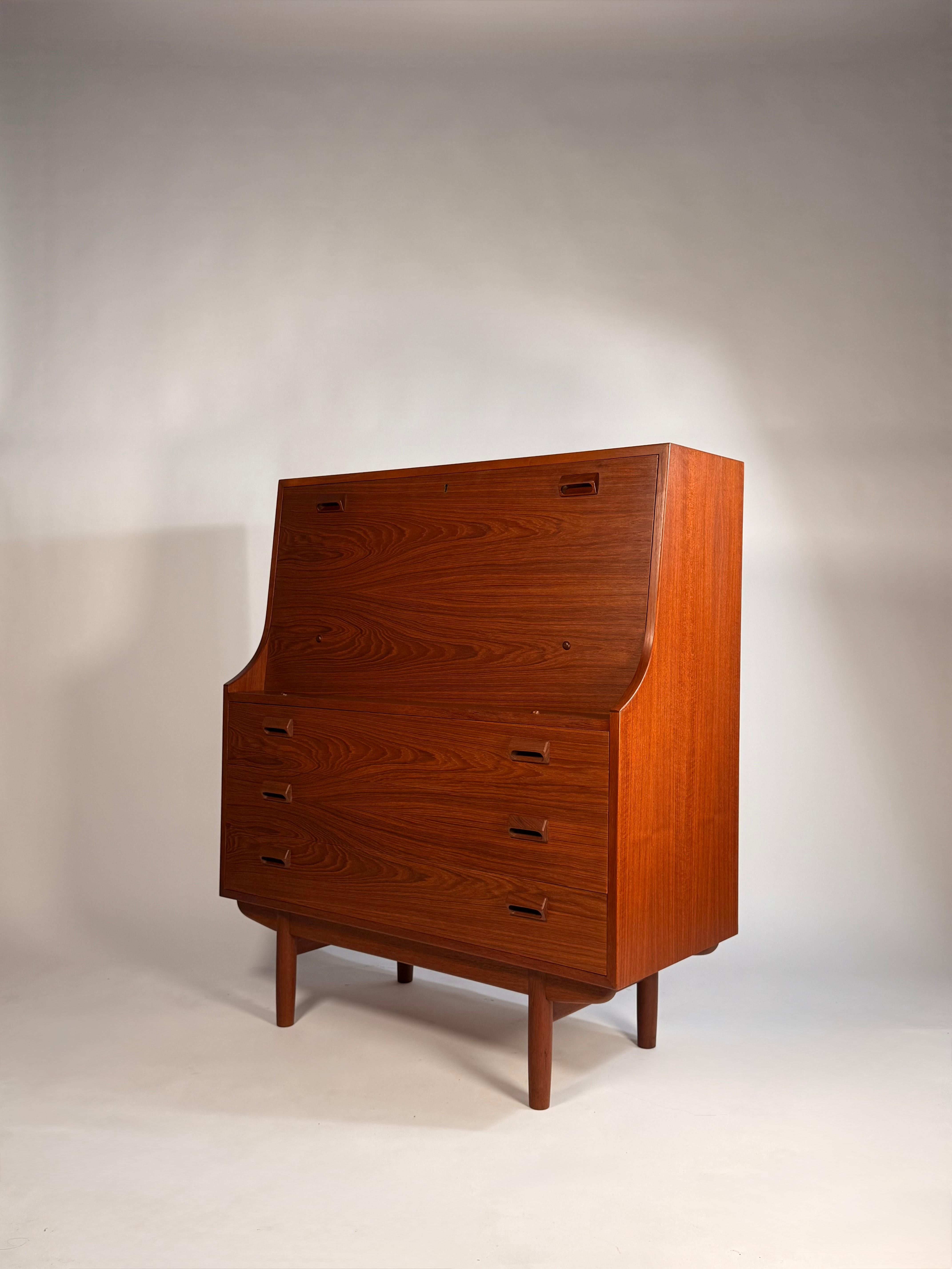 Danish Secretary Desk by Børge Mogensen for Soborg Mobler, circa 1960's. This gorgeous teak drop-front secretary desk has three storage drawers. Tall tapered legs under a teak case gives this piece an elegant profile typical of Danish Modern pieces.