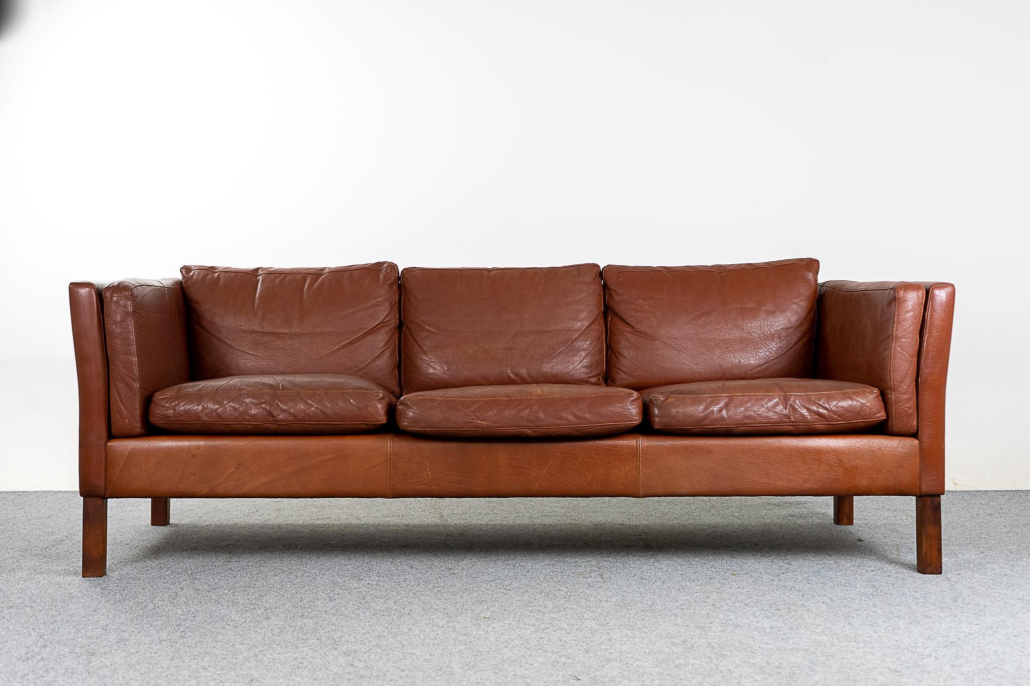 Leather mid-century sofa, circa 1960's. Original leather is soft and supple while also being durable to ensure years of use and enjoyment. Seats have some staining.

Please inquire for remote and international shipping rates.