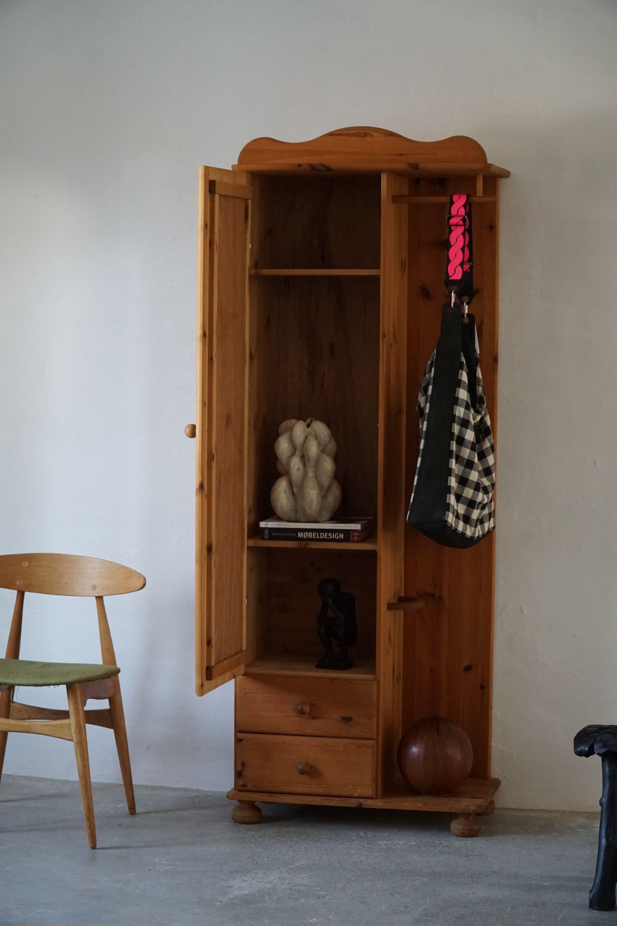 Fine cabinet in solid pine with a mirror, perfectly suited for a bedroom or entré. Made in Denmark, ca 1980s.

A great brutalist object, perfect for the modern interior. A warm colour and patina that pair well with the minimalist scandinavian