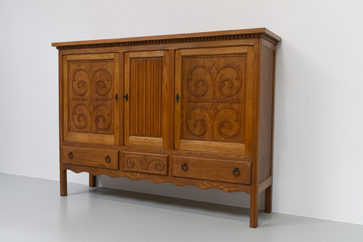 Danish Modern Brutalist Sideboard in Oak, 1950s.
Beautiful and sculptural Mid-Century Modern Danish highboard in oak that offers plenty of storage space. Made in Denmark in the 1950s with hand carved details and wrought iron drawer pulls. 

This