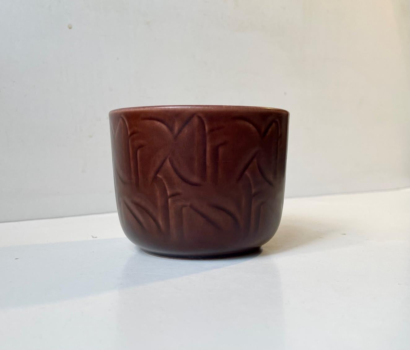 Small ceramic Vase/planter designed by Nils Thorsson and manufactured by Aluminia in Denmark during the 1950s. It is executed in a fated maroon/burgundy toned glaze with underlying abstract motifs. Model number 683 - very rare. Close related to the
