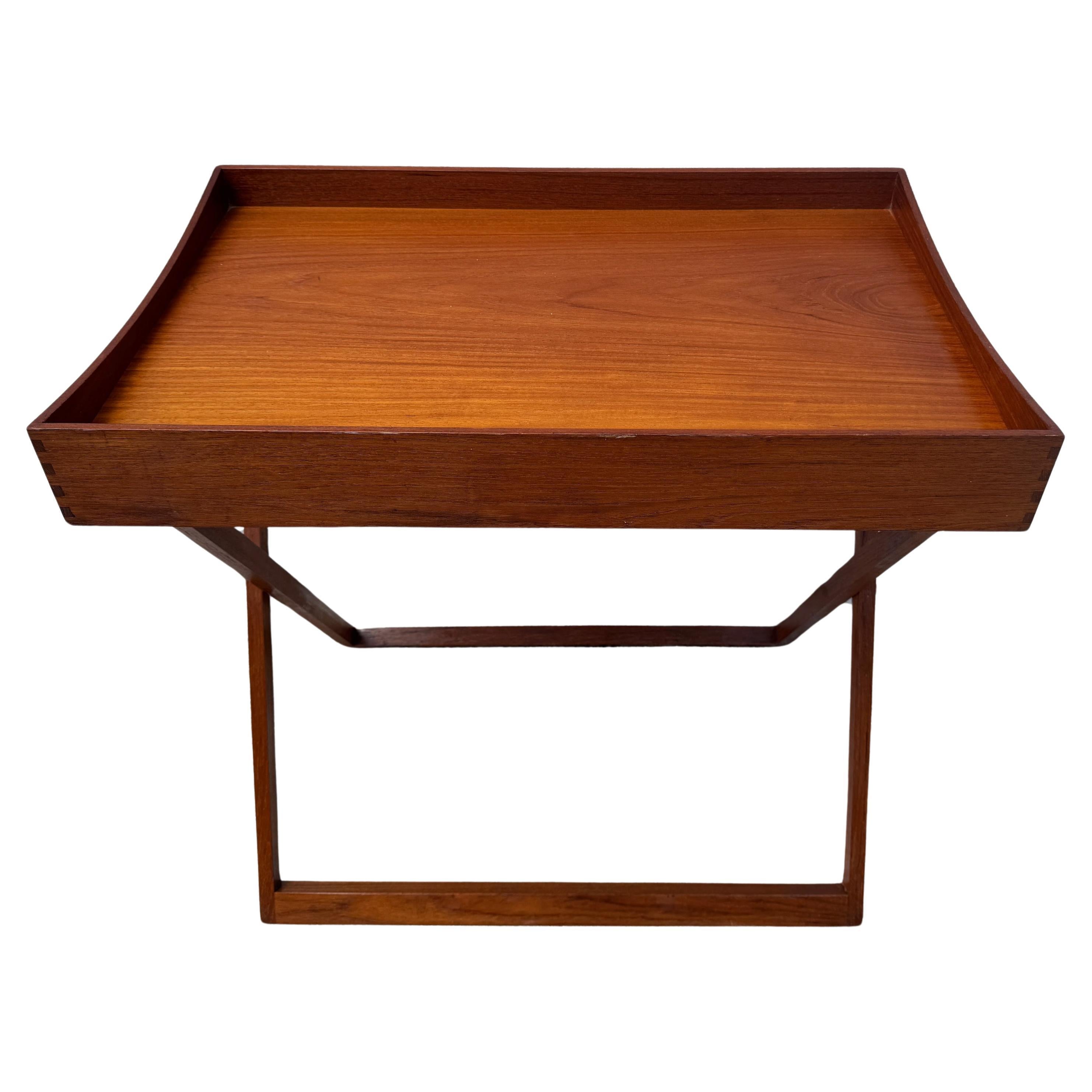Danish Modern Campaign Style Teak and Black Lacquer Reversible Tray Table, Denmark, 1960s

A versatile Danish Modern Campaign Style teak and black lacquer reversible tray coffee table from the 1960s. This elegantly designed table is made in two