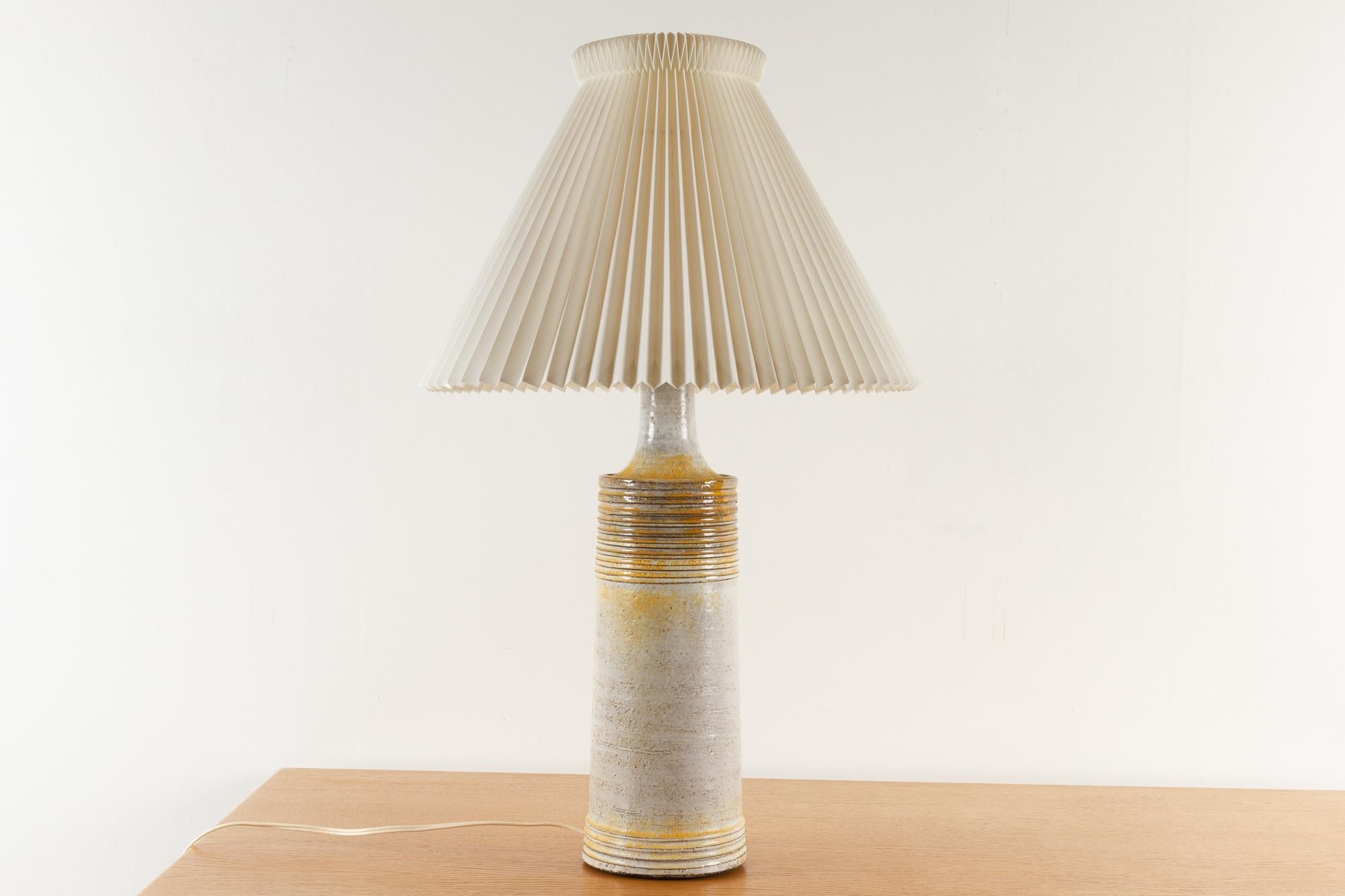 Danish Modern Ceramic Frimann table lamp, 1970s
Tall ceramic lamp in earth colors with yellow accents. Fitted with original pleated Le Klint shade.
Makers mark on socket.
E26/27
Very good original condition.