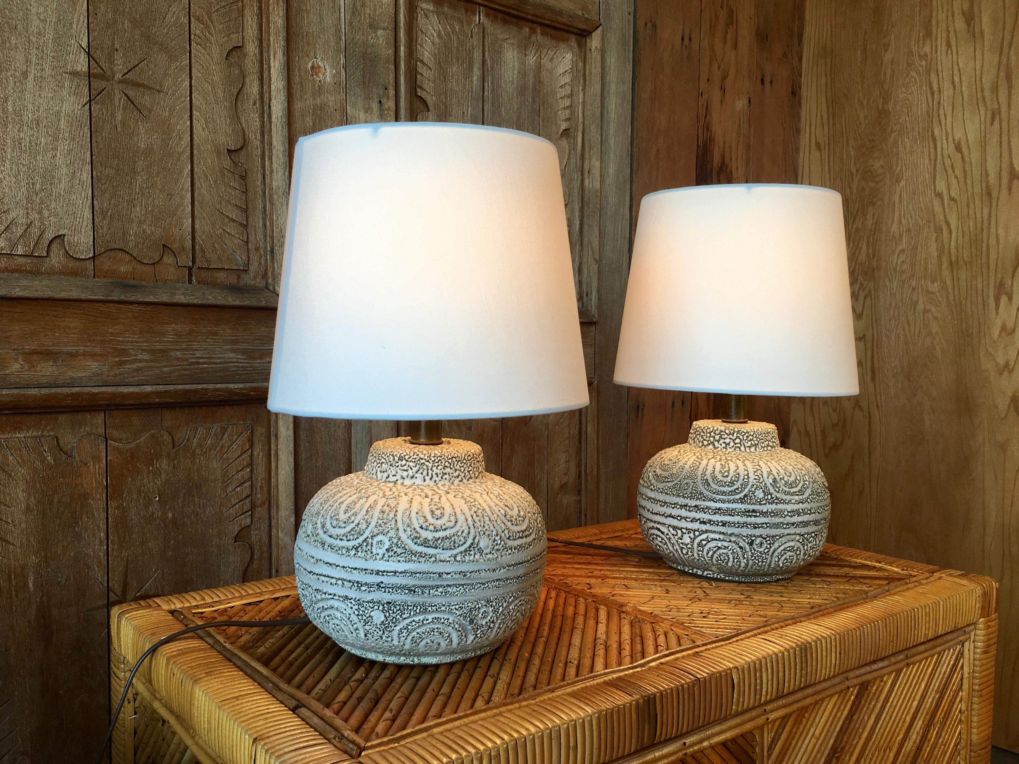 Pair of Danish sculpted glazed pottery lamps in grey and oatmeal color. Lampshades are new and included.