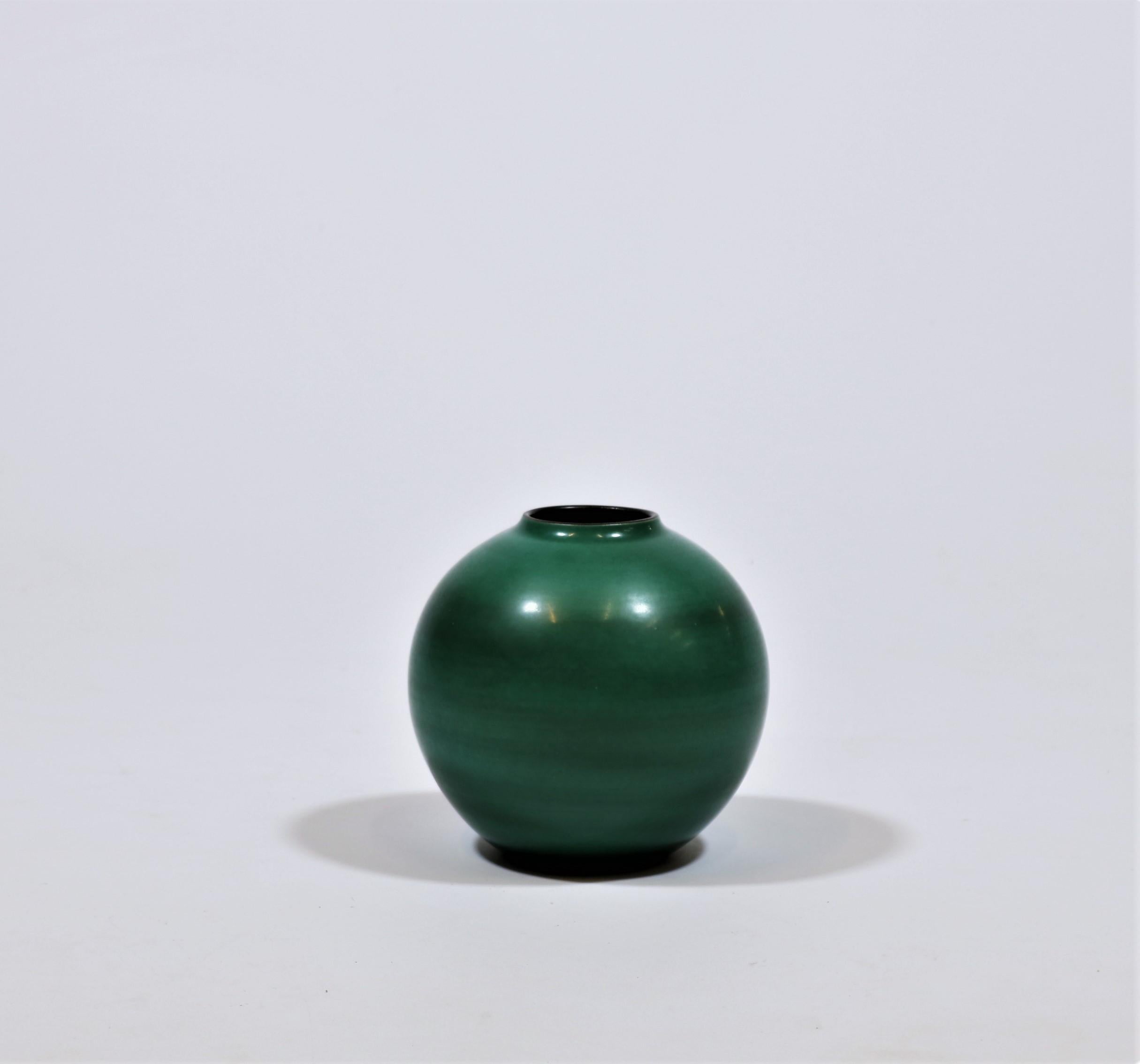 Elegant and organic shaped vase in green shades handmade by Nils Thorsson at Royal Copenhagen, Denmark in 1944.
Due to shortage of materials during WWII the Danish Royal Stoneware Factory (Royal Copenhagen) had to use local raw materials which is