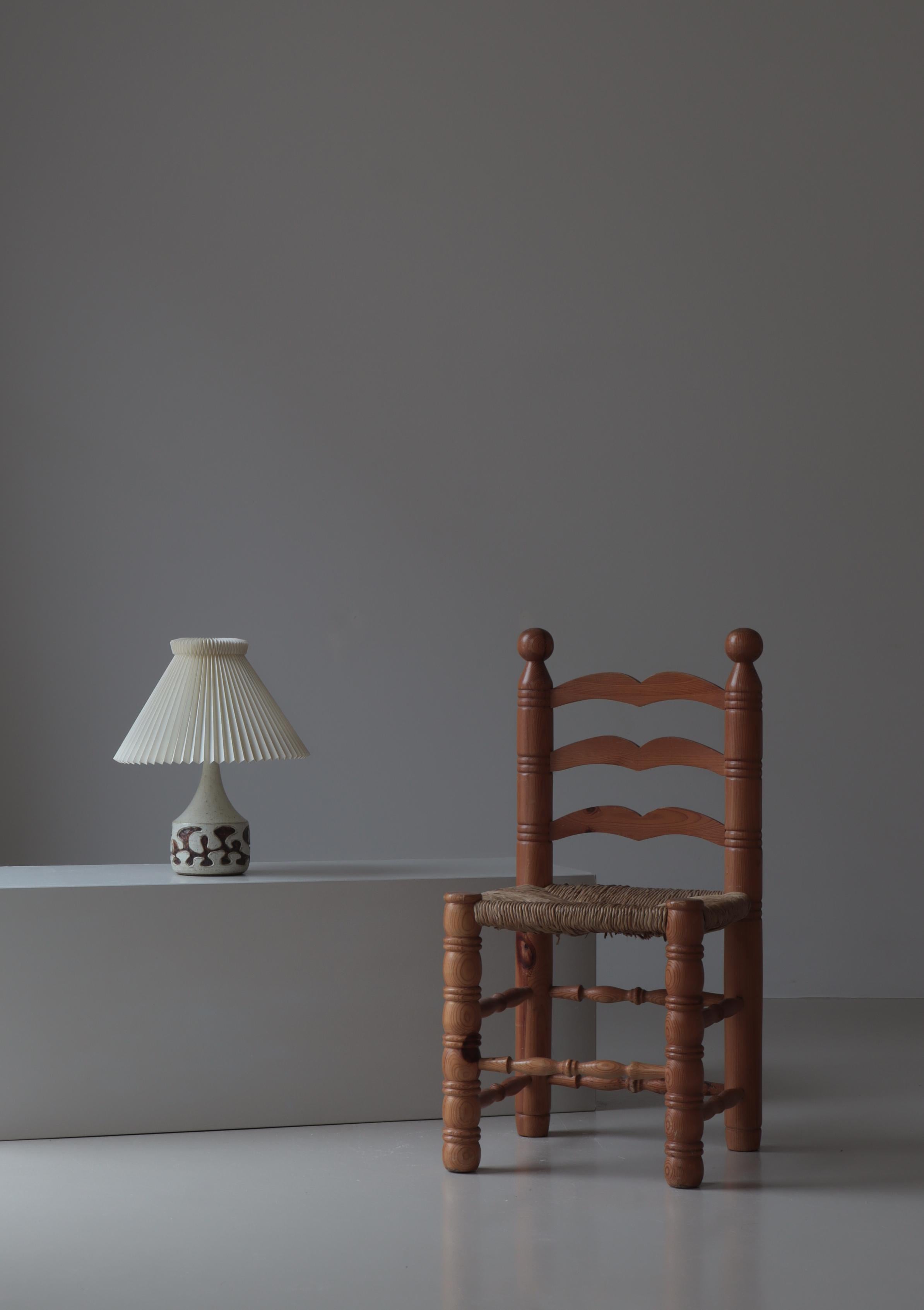 Unique table lamp handmade in the 1970s at Axella studio, Denmark. The lamp is made from stoneware and decorated with abstract geometric figures. Painted and glazed in brown and white. Mounted with a vintage hand folded Le Klint shade. Stamped