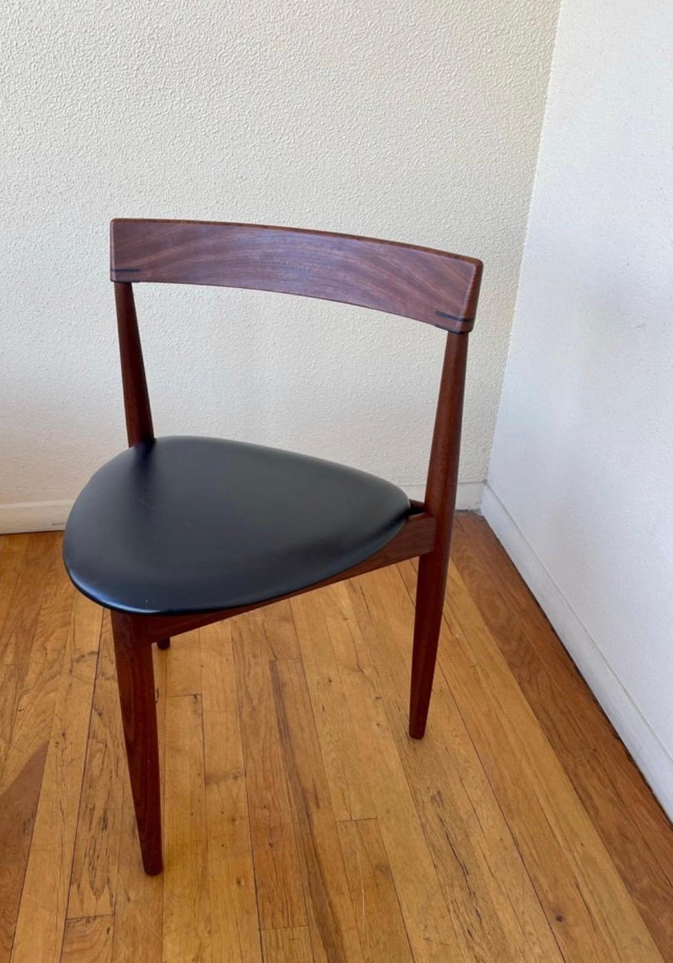 Danish modern, dining chair by Hans Olsen for Frem Rojle features contoured dark teak frames with 3 legs and Naugahyde, triangular seat.