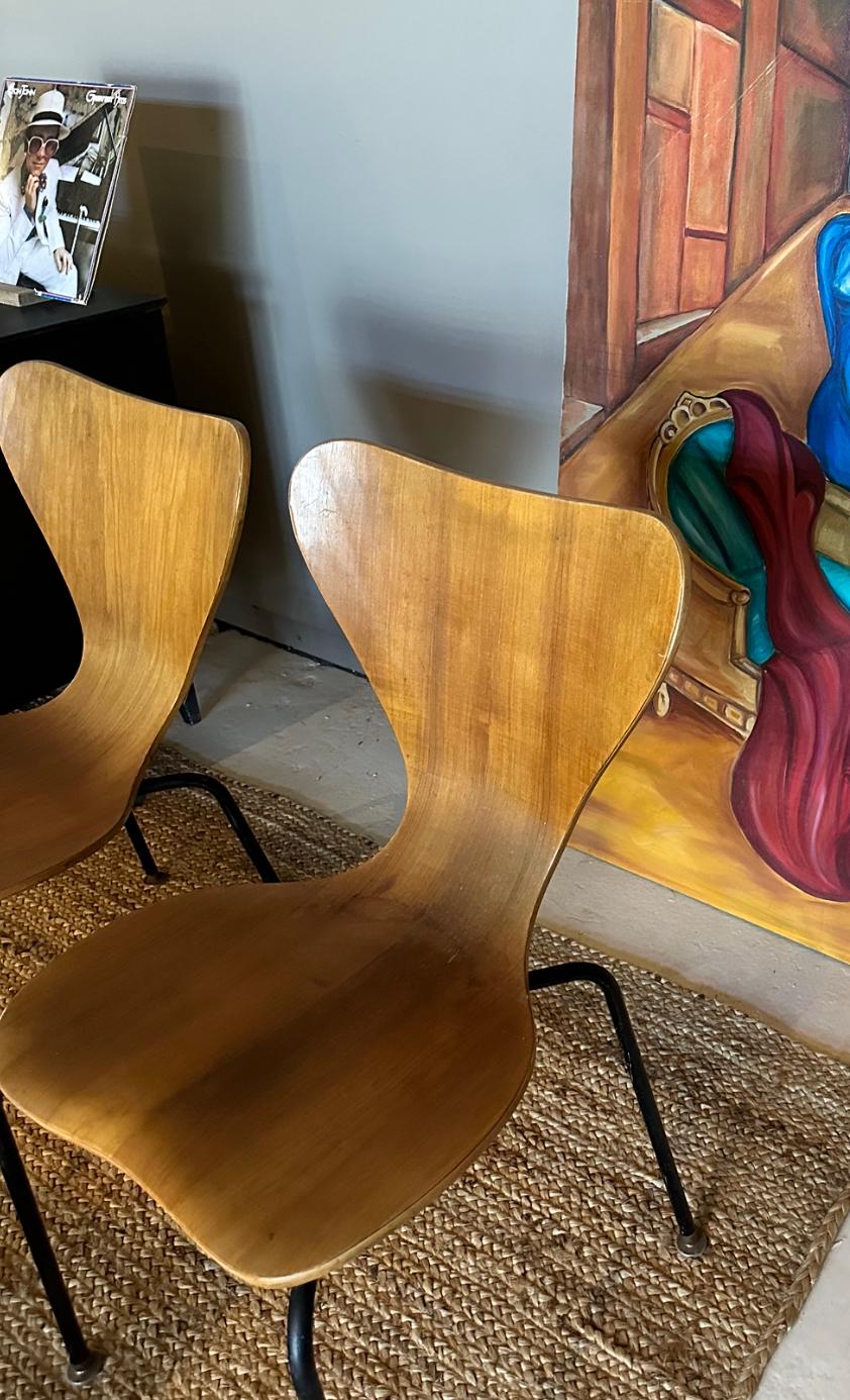 Circa 1950 pressed teak plywood , bent curved seat on steel tubing base and frame.Becoming more and more rare and sought after as the originator for this timeless style. Made in Denmark, these chairs sit quite comfortably.
i have four of these