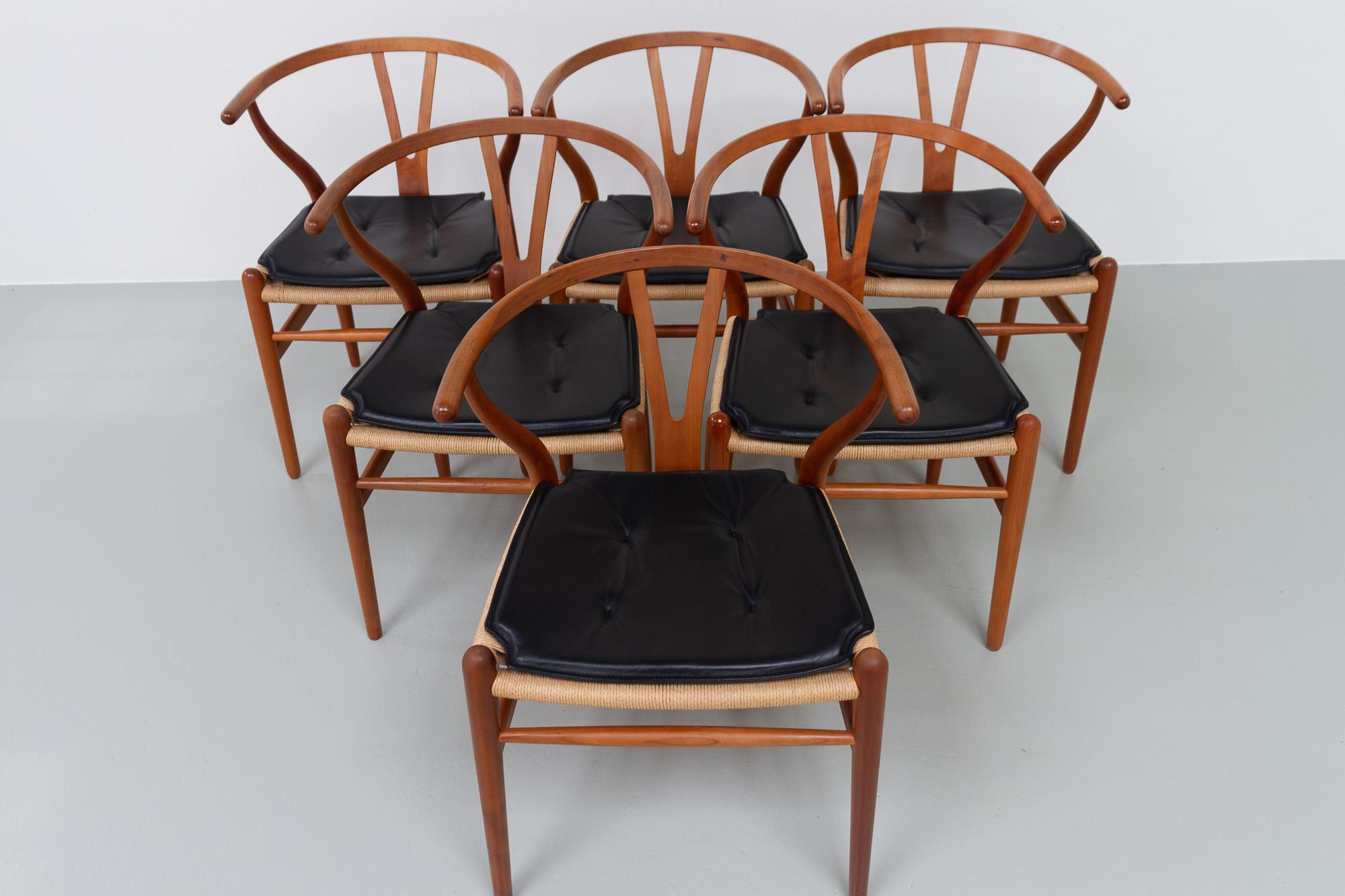 Danish Modern Cherry CH24 Wishbone Chairs by Hans J. Wegner, 1990s.

Designed in 1949 by Danish designer Hans Jørgensen Wegner for Carl Hansen & Søn, Denmark. Also known as the Y Chair.
Set of six iconic Scandinavian modern dining chairs in