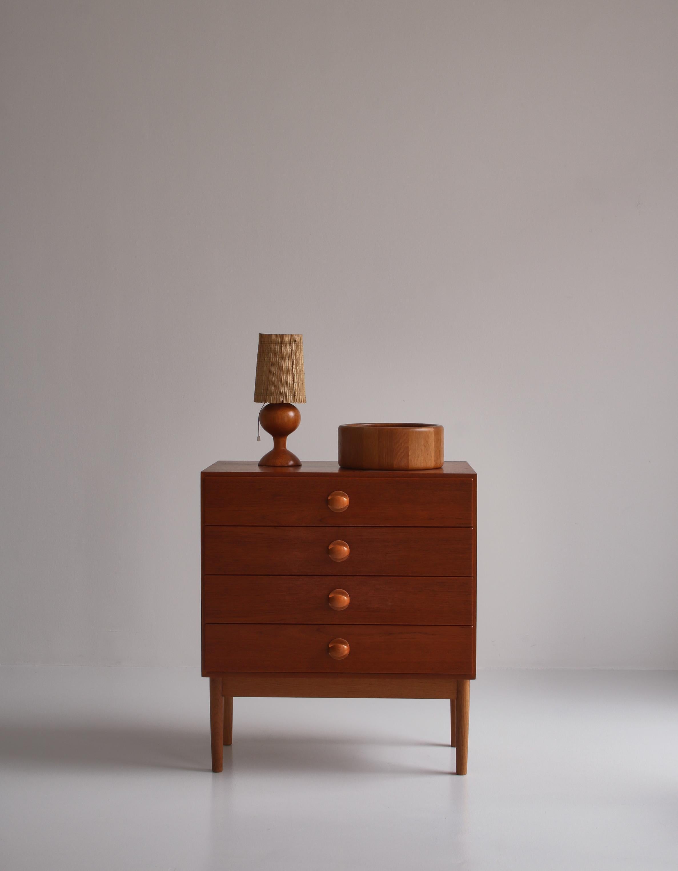 Rare and important chest with four drawers in teak designed by Vilhelm Wohlert in 1958 and manufactured at Næstved Møbelfabrik, Denmark. The minimalistic design features beautifully hand carved knots in solid oak. Great condition.